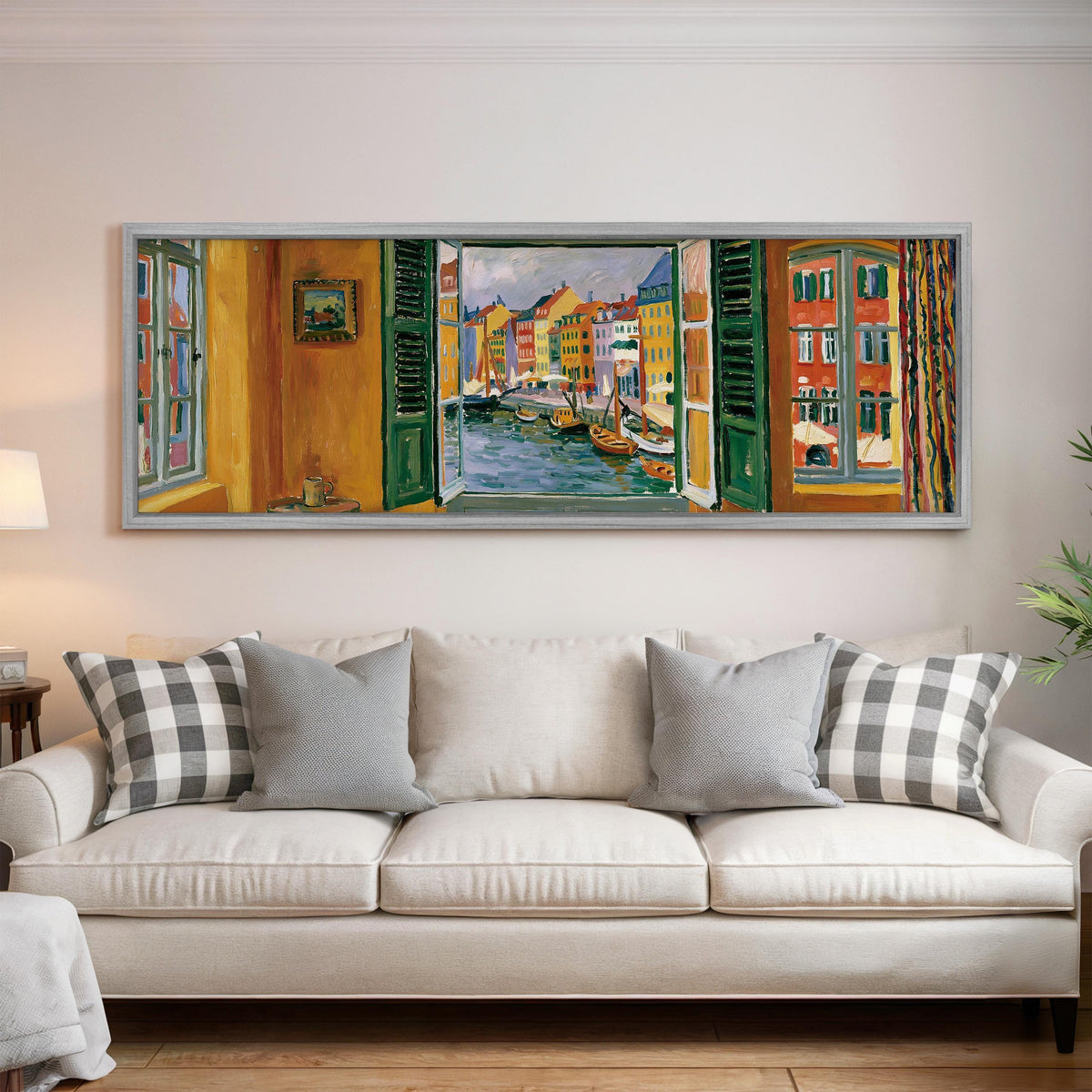 Copenhagen's colorful canal through a window panoramic canvas print above a white sofa in a bright living room