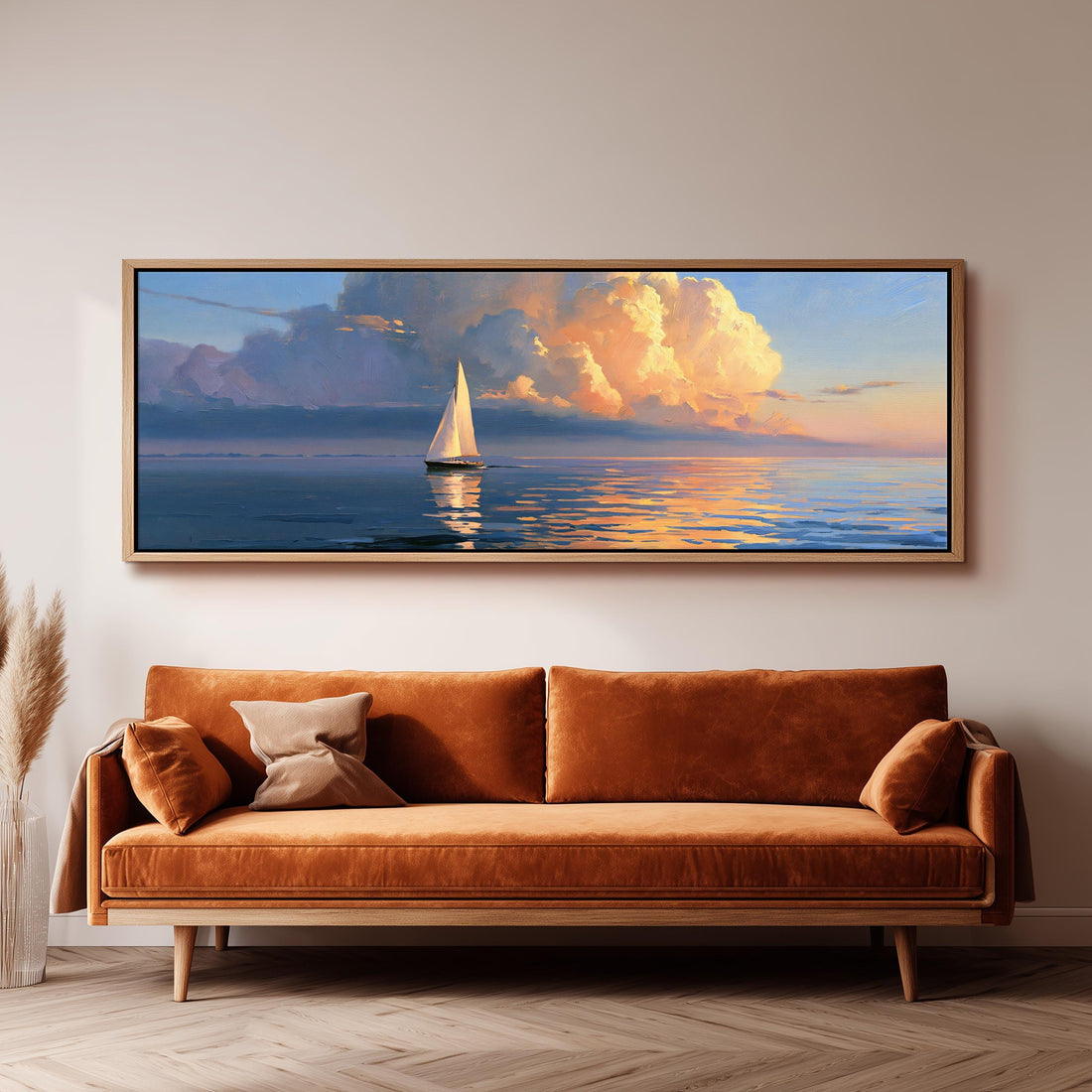Sailboat at sunset under golden clouds long horizontal canvas print above a sofa in a living room