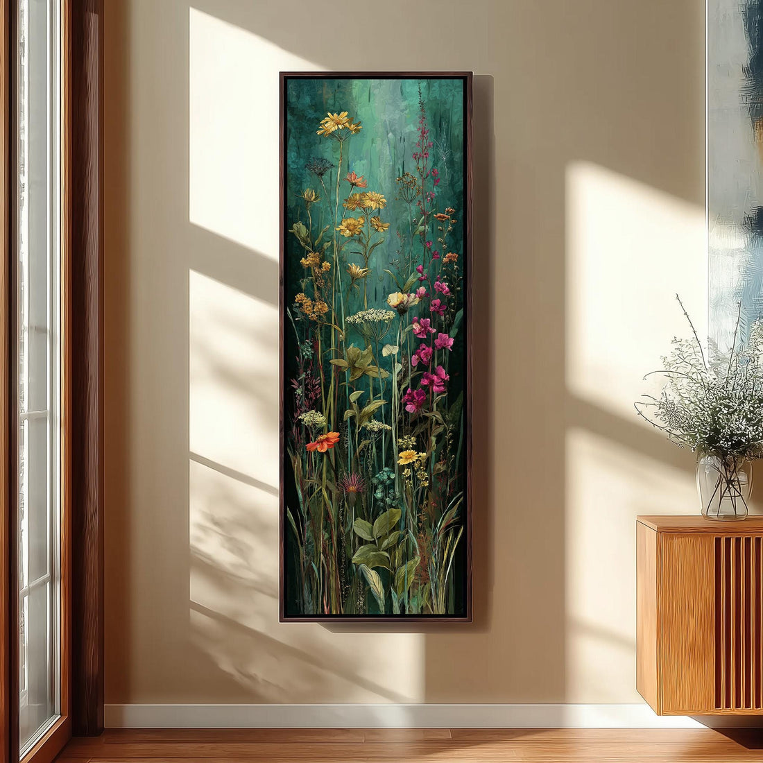 a large, framed painting of a lush, colorful garden scene hanging on a wall.