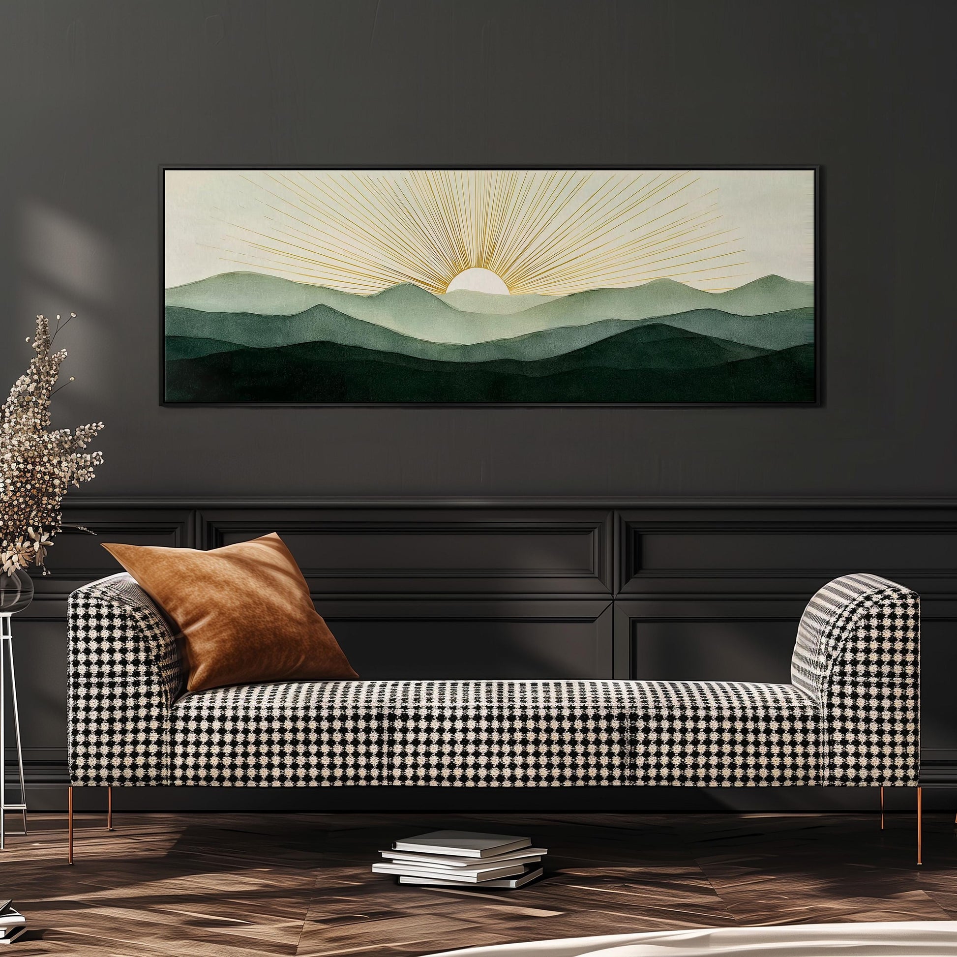 a large, framed painting of a mountain landscape with a sun in the background, hanging on a wall above a black and white checkered sofa.