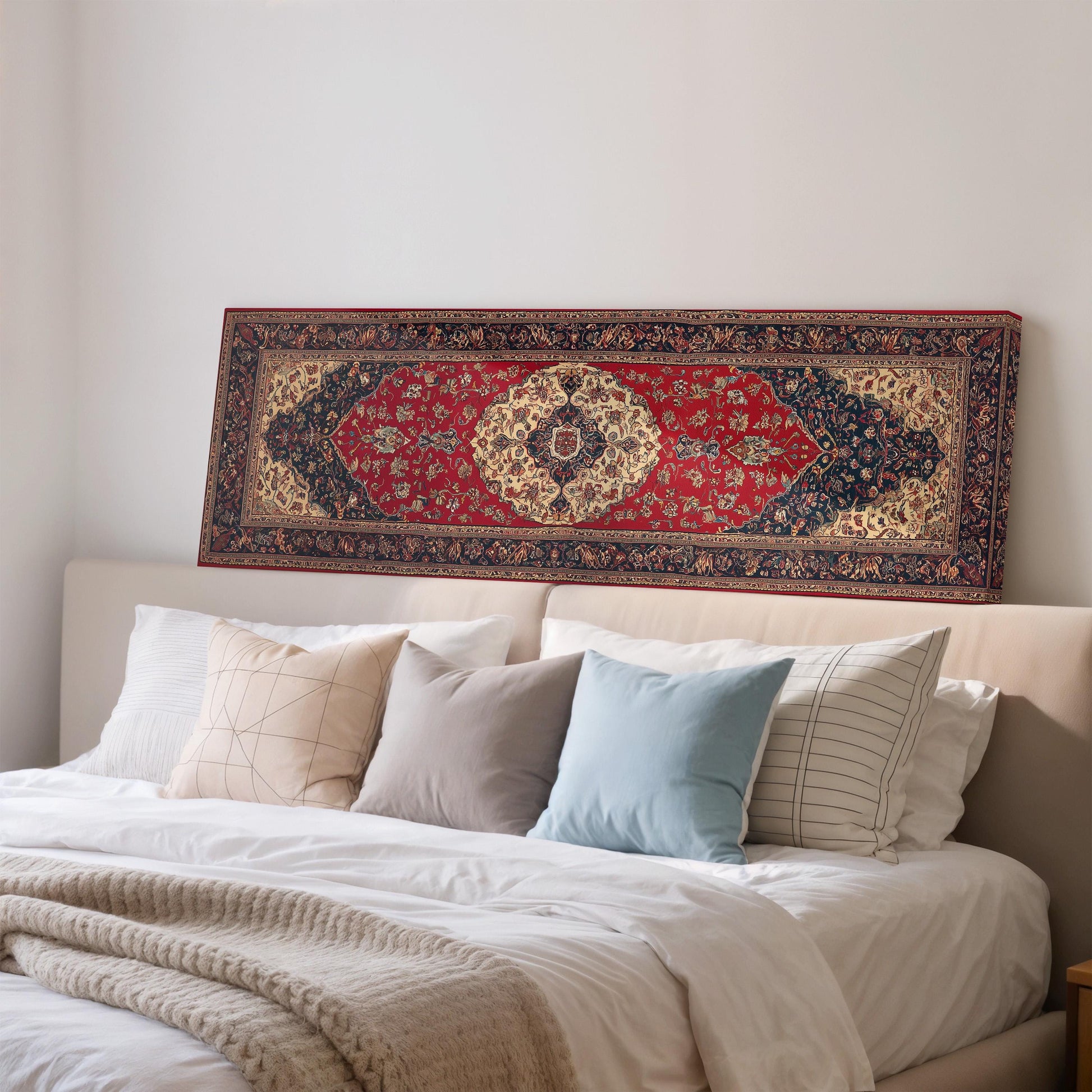 a cozy bedroom with a large, colorful rug on the wall above a bed with white pillows and a gray blanket.