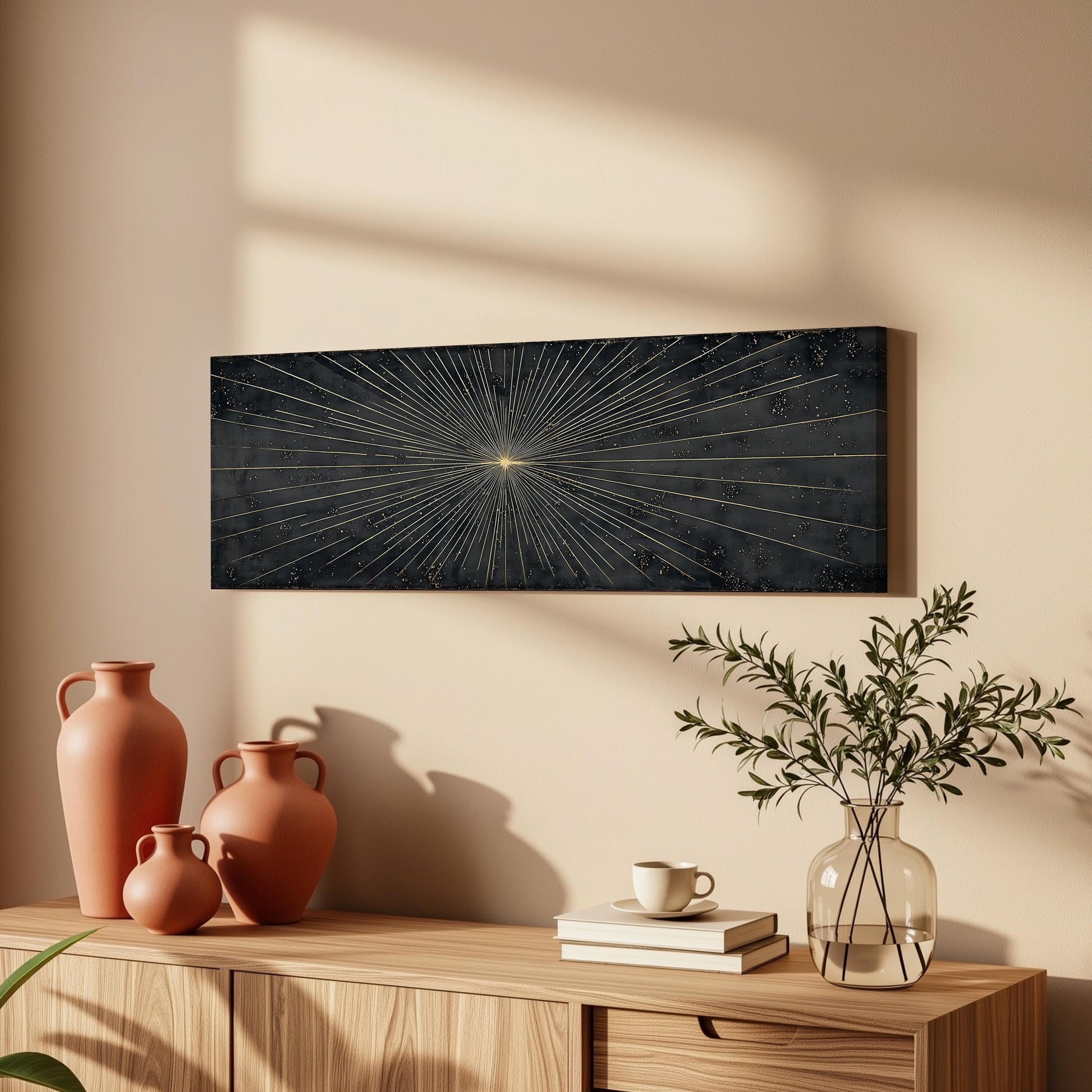 a wooden cabinet with a black abstract painting hanging on the wall above it, along with three orange vases and a glass vase with greenery.