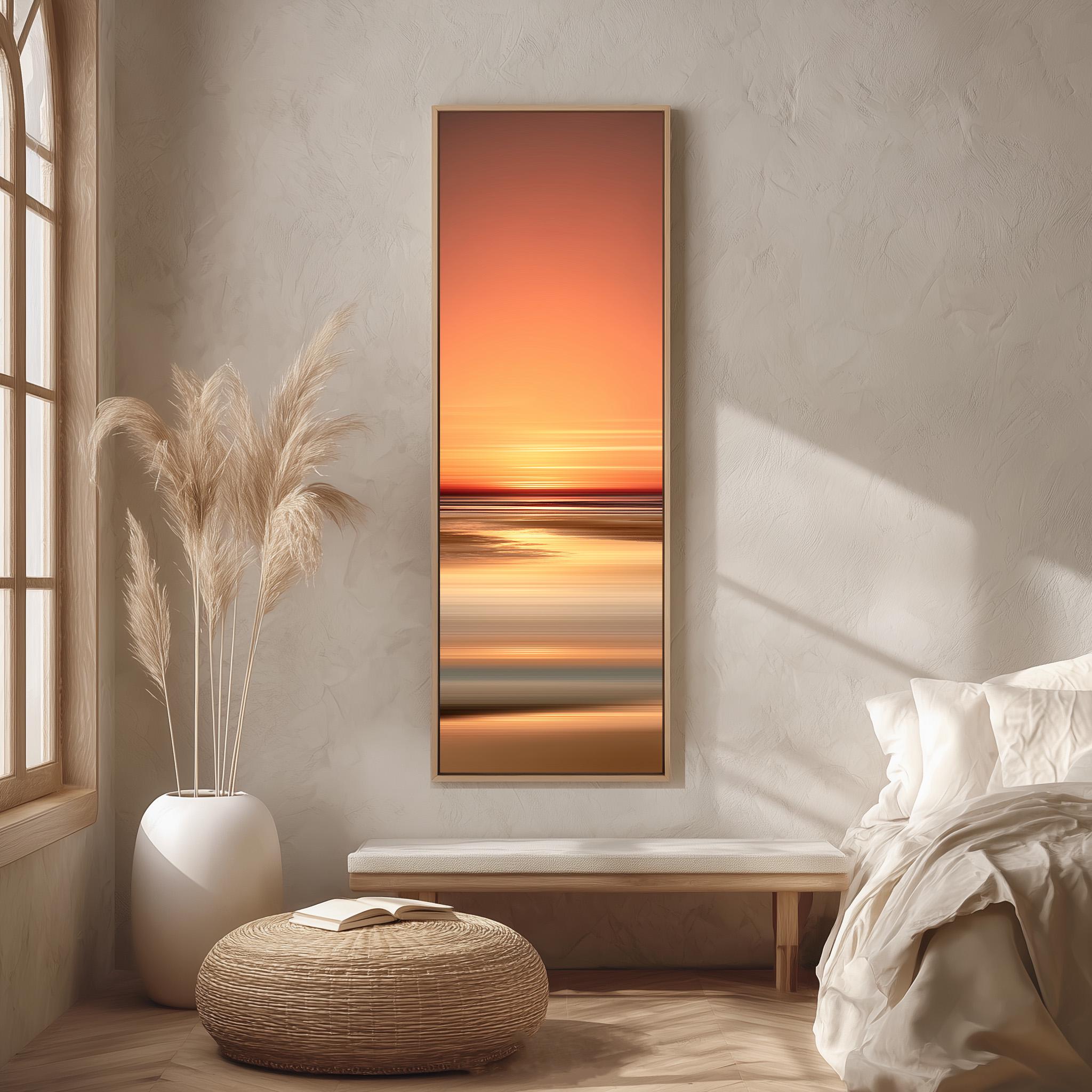 a serene bedroom scene with a large window, a white bed, a woven ottoman, and a framed landscape painting of a sunset over the ocean.