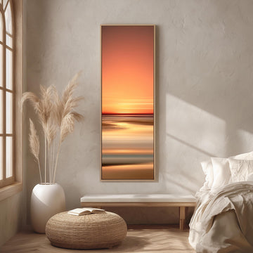 a serene bedroom scene with a large window, a white bed, a woven ottoman, and a framed landscape painting of a sunset over the ocean.