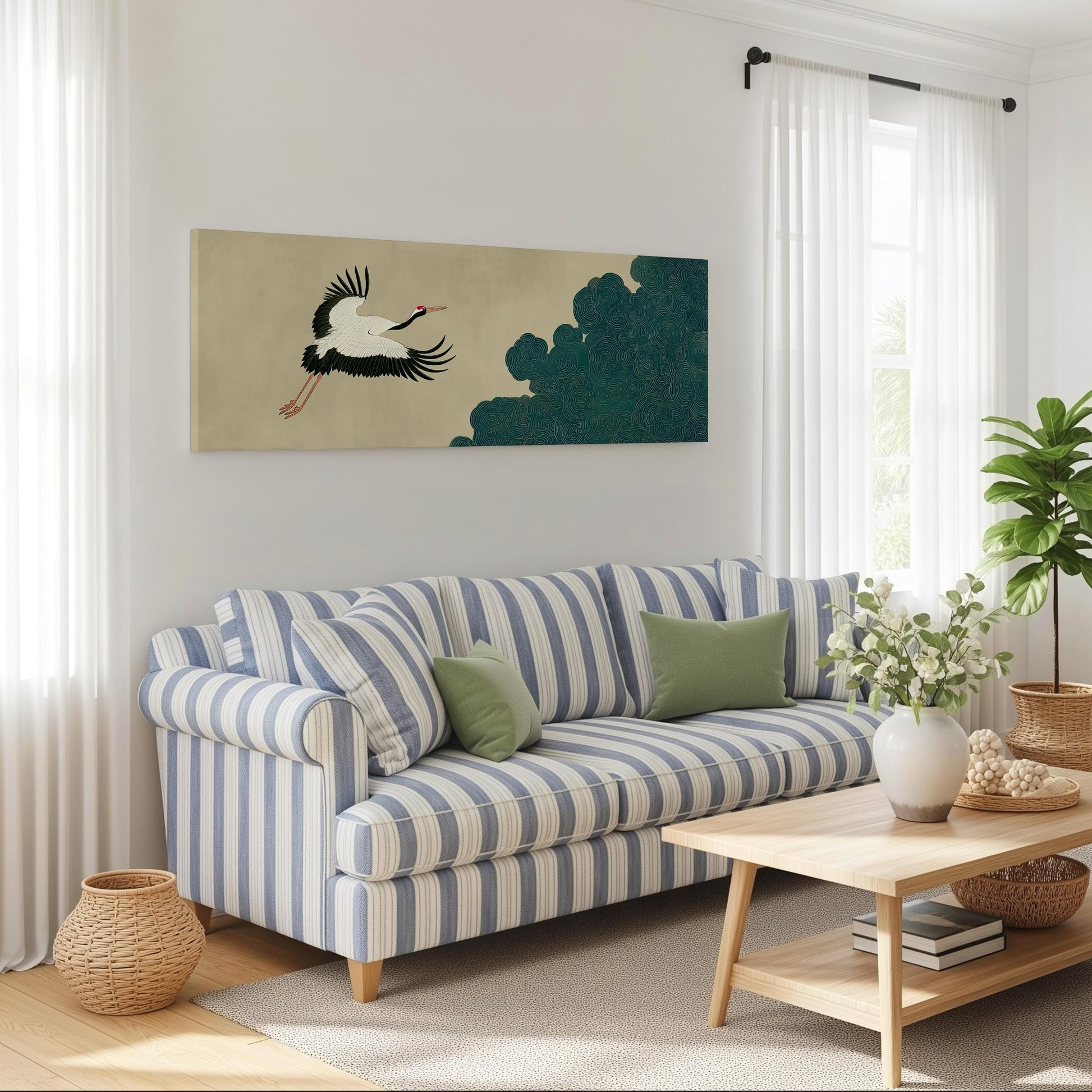 a cozy living room with a striped blue and white sofa, a wooden coffee table, and a large painting of a crane in flight on the wall.