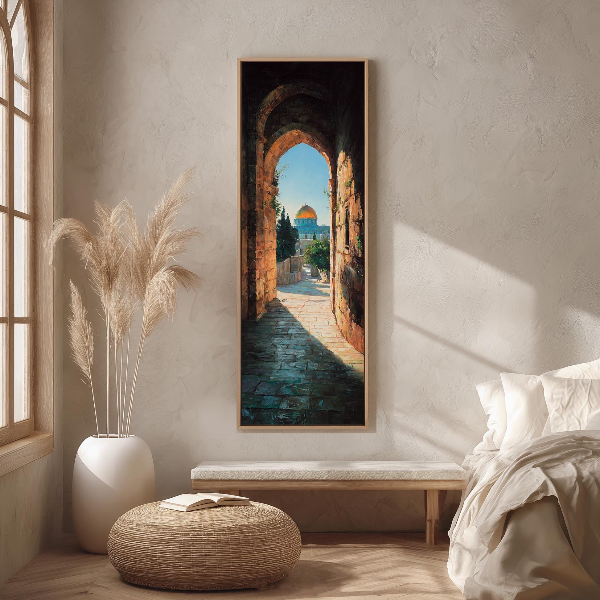 a serene and minimalist bedroom setting with a large window, a painting of an archway leading to a garden, a white bench, and a woven ottoman.