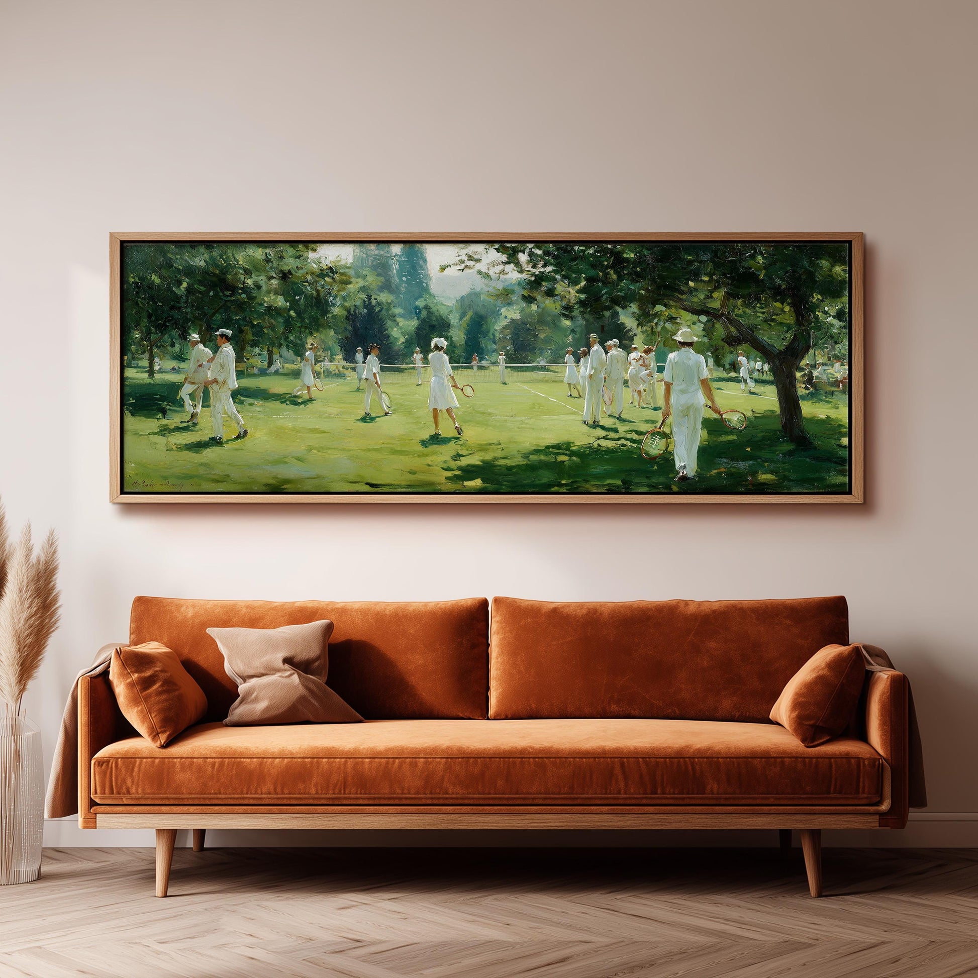a large painting of a group of people playing cricket in a lush green field, hanging on a wall above a brown sofa.