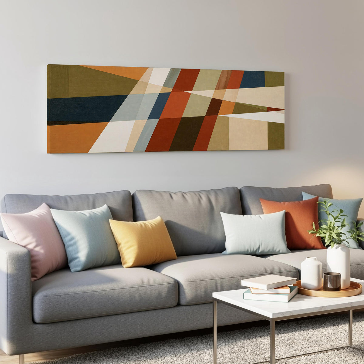 Rust and navy diagonal color blocks panoramic canvas print above a grey sofa in a living room