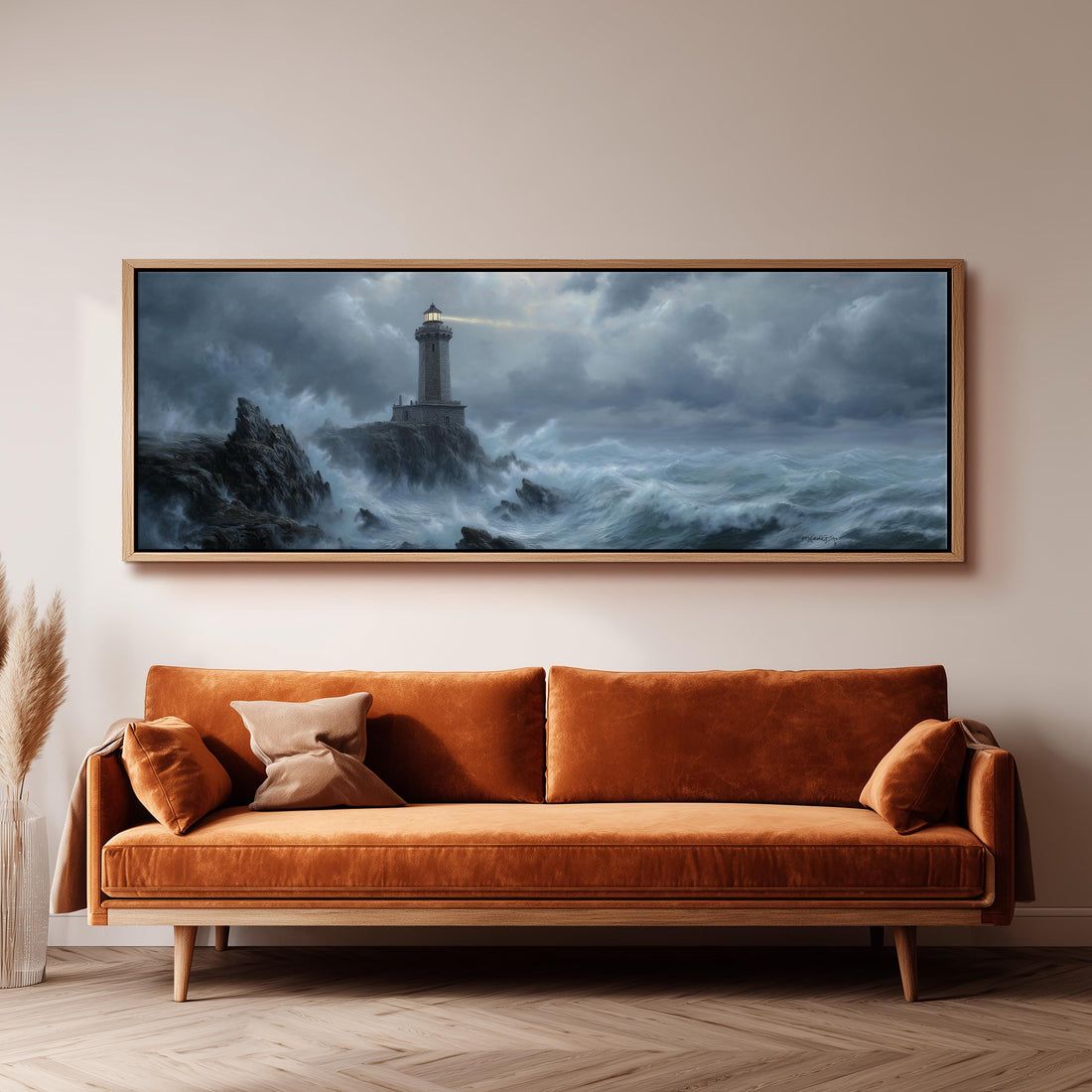 a large painting of a lighthouse on a stormy sea hanging on a wall above a white sofa with patterned throw pillows.
