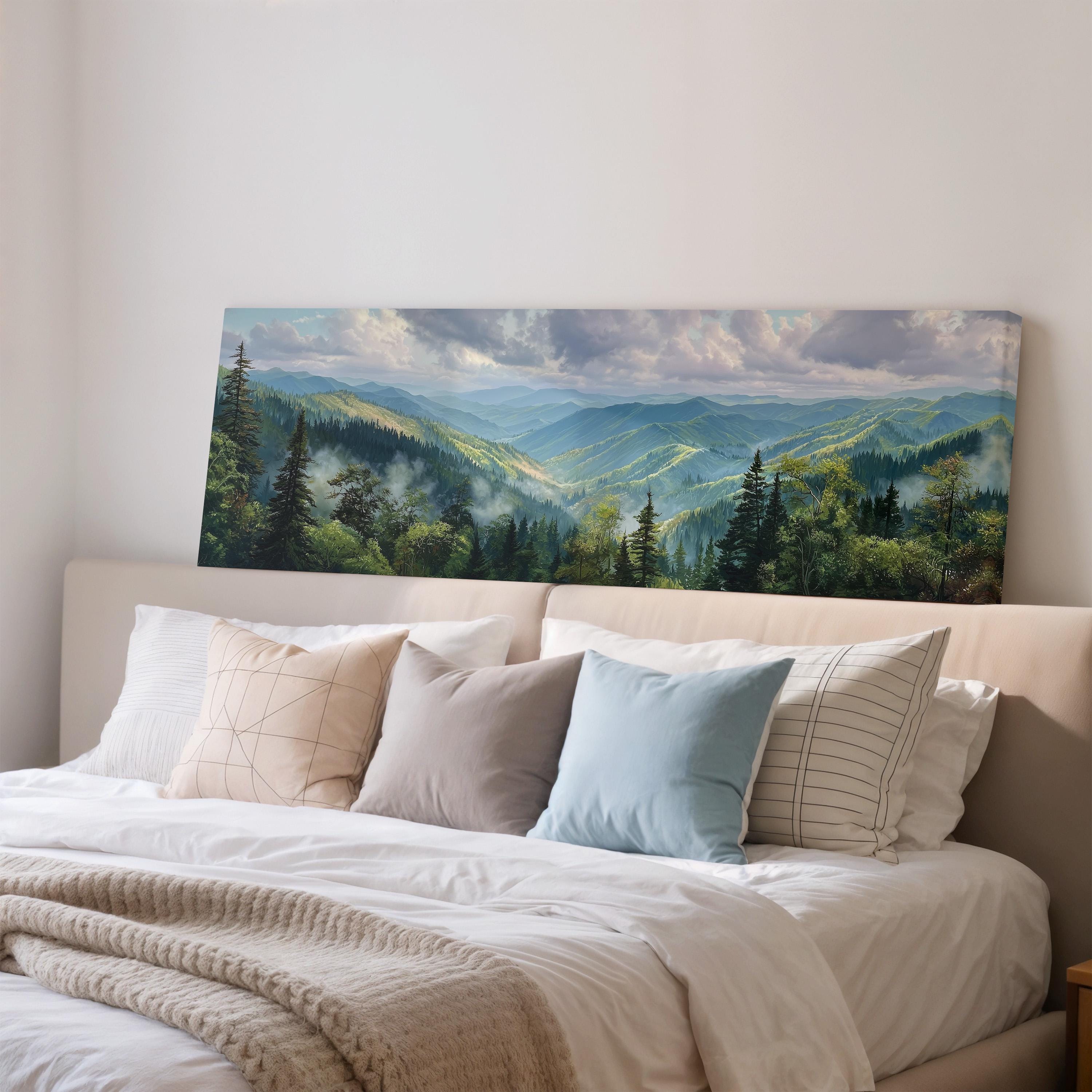 a large landscape painting hanging on a wall above a bed with white bedding and pillows.