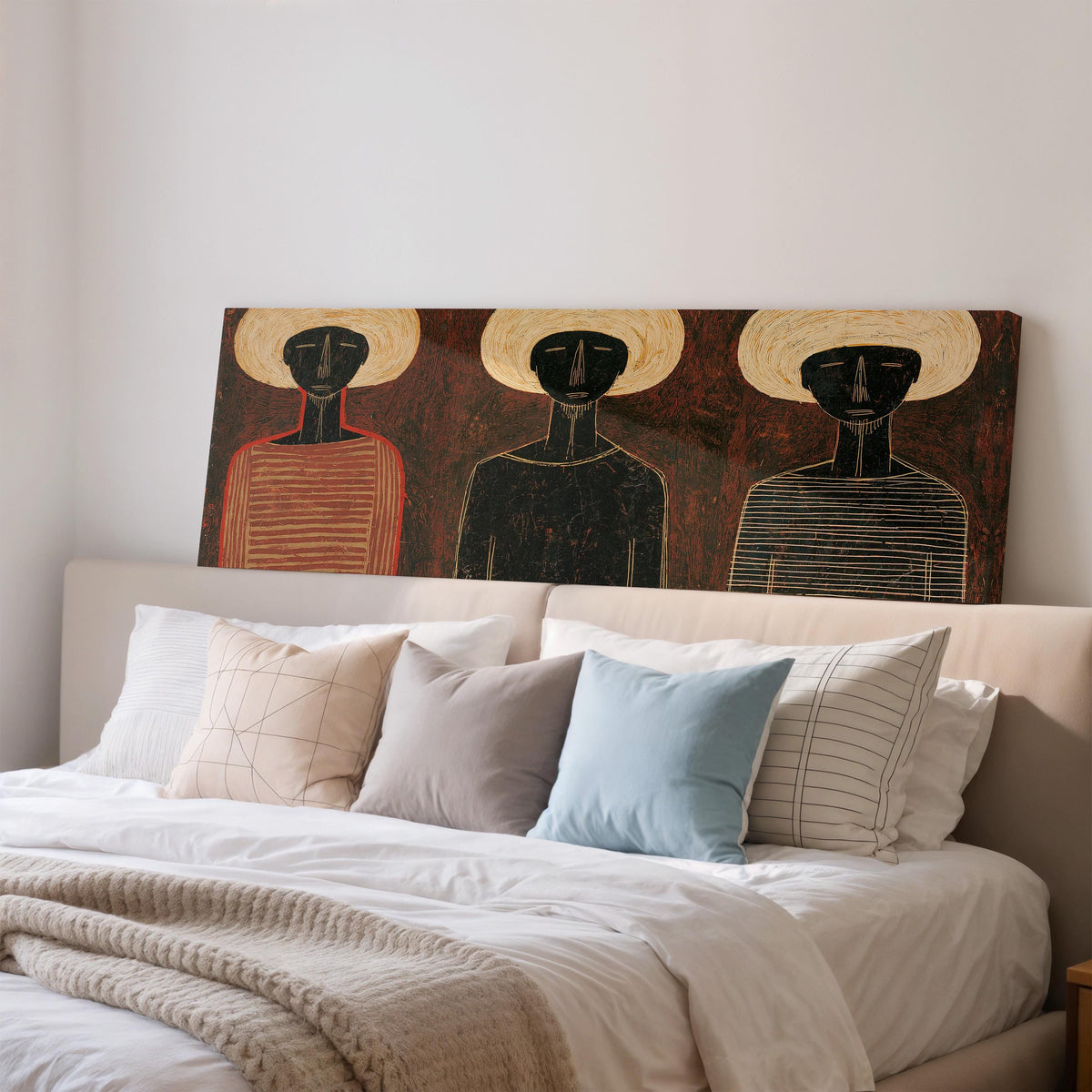Three figures in striped shirts wide panoramic canvas print above a bed in a bedroom