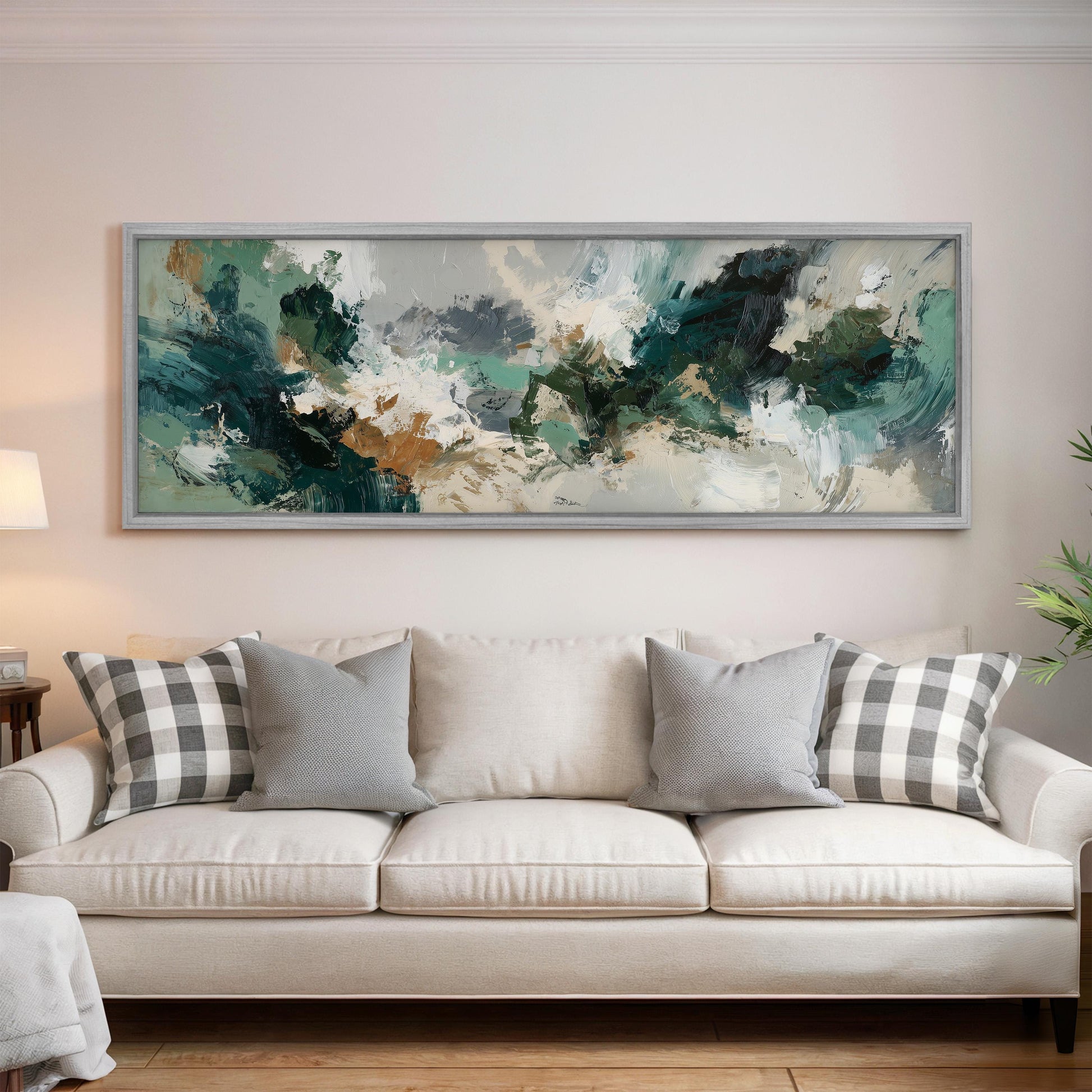 a large, abstract painting hanging on a wall above a white sofa with gray and white plaid throw pillows.