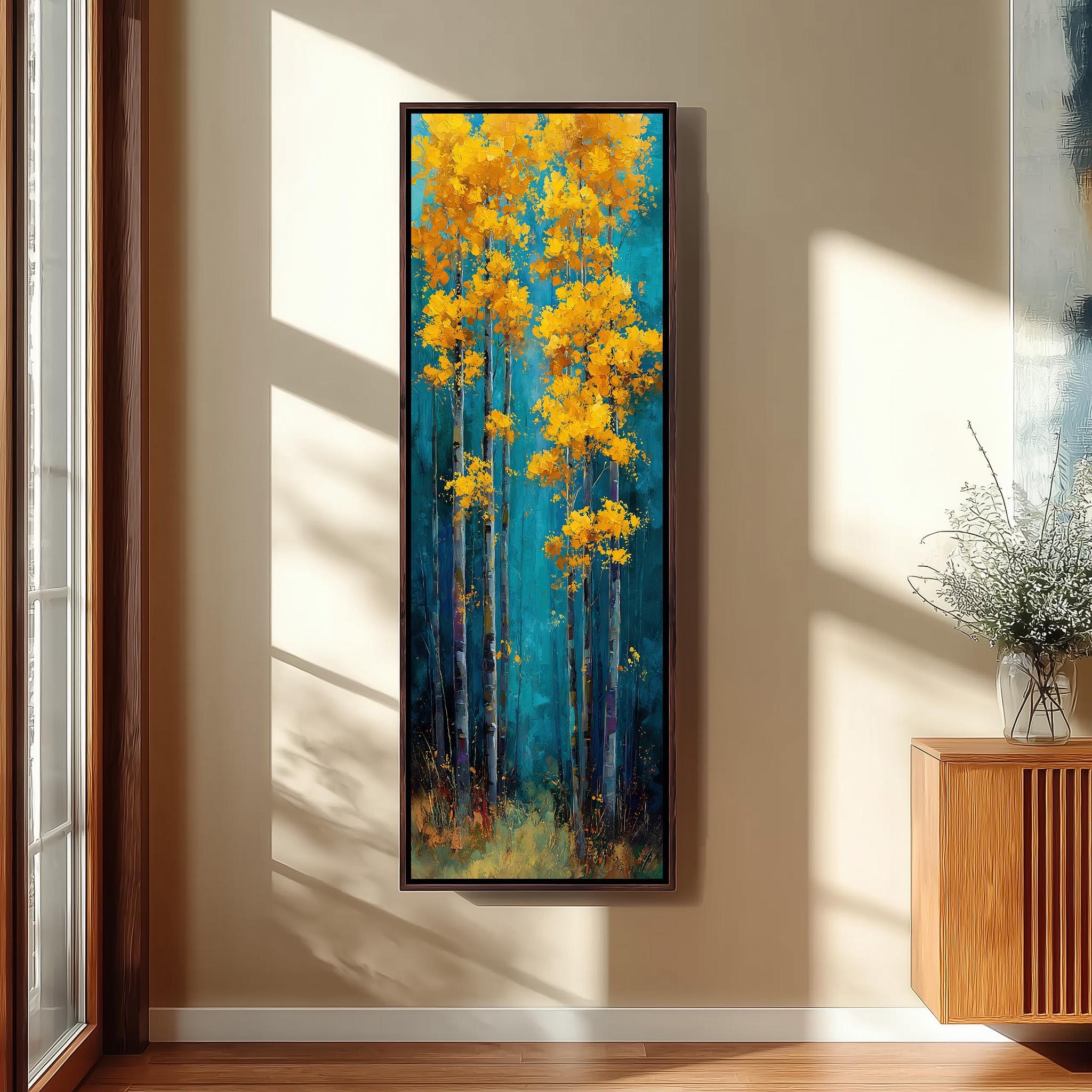 a large painting of a forest scene with tall trees in shades of blue and yellow, hanging on a wall in a room with a wooden floor and a window.