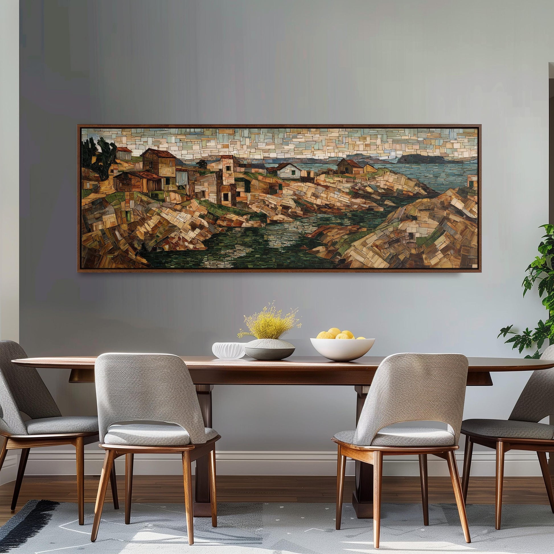 a dining room with a large, colorful painting of a coastal town hanging on the wall above a wooden dining table with four chairs. The table is set with a bowl of fruit and a vase of flowers, creating a welcoming and inviting atmosphere.