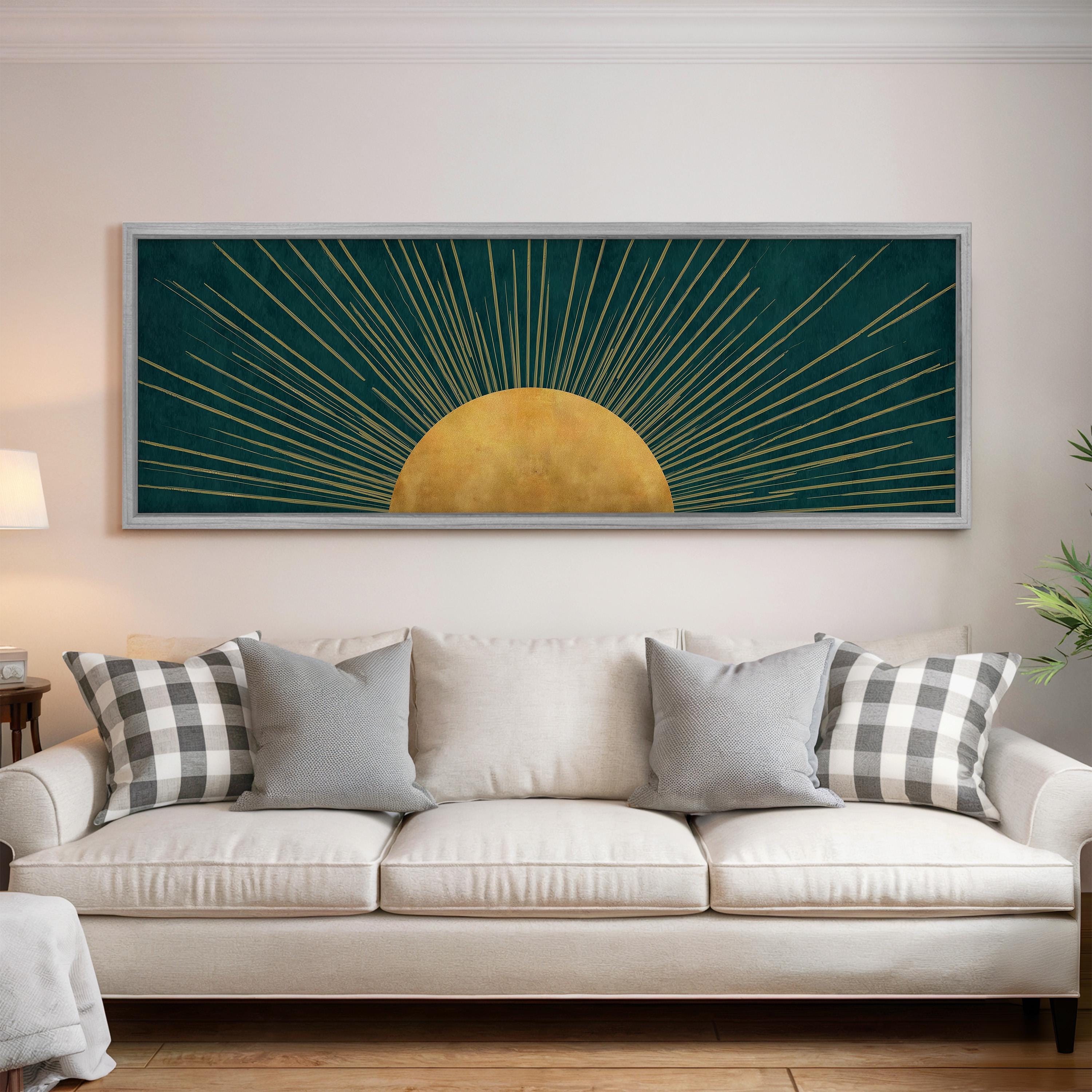 a large framed artwork hanging on a wall above a white sofa with gray and white plaid throw pillows.