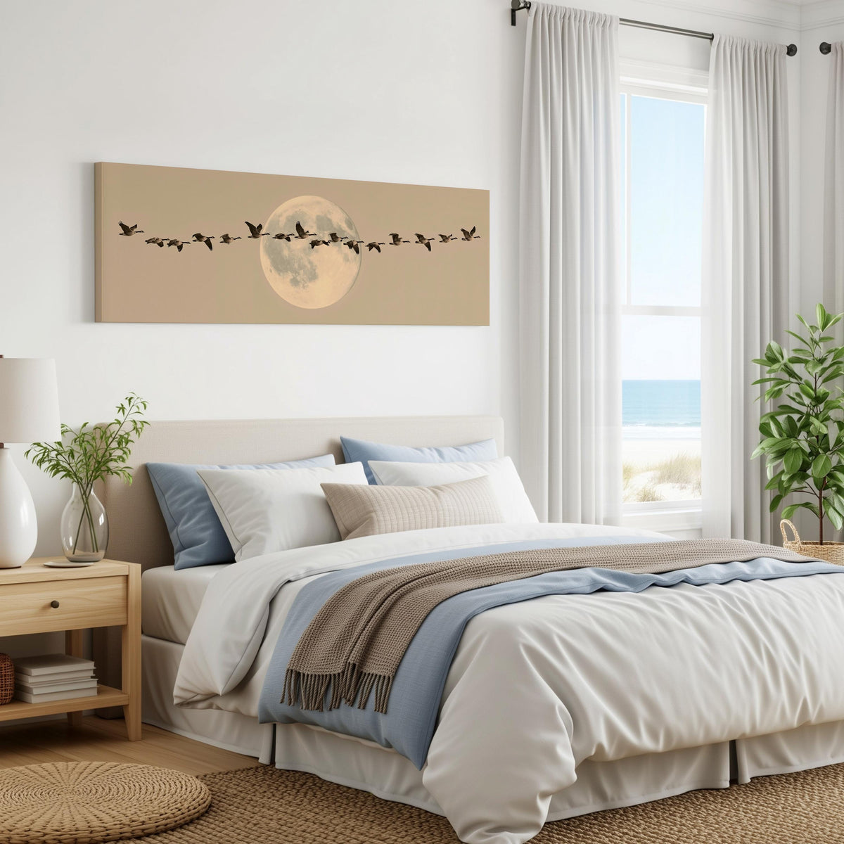 Geese flying across a pale moon on sand panoramic canvas print above a bed in a coastal bedroom
