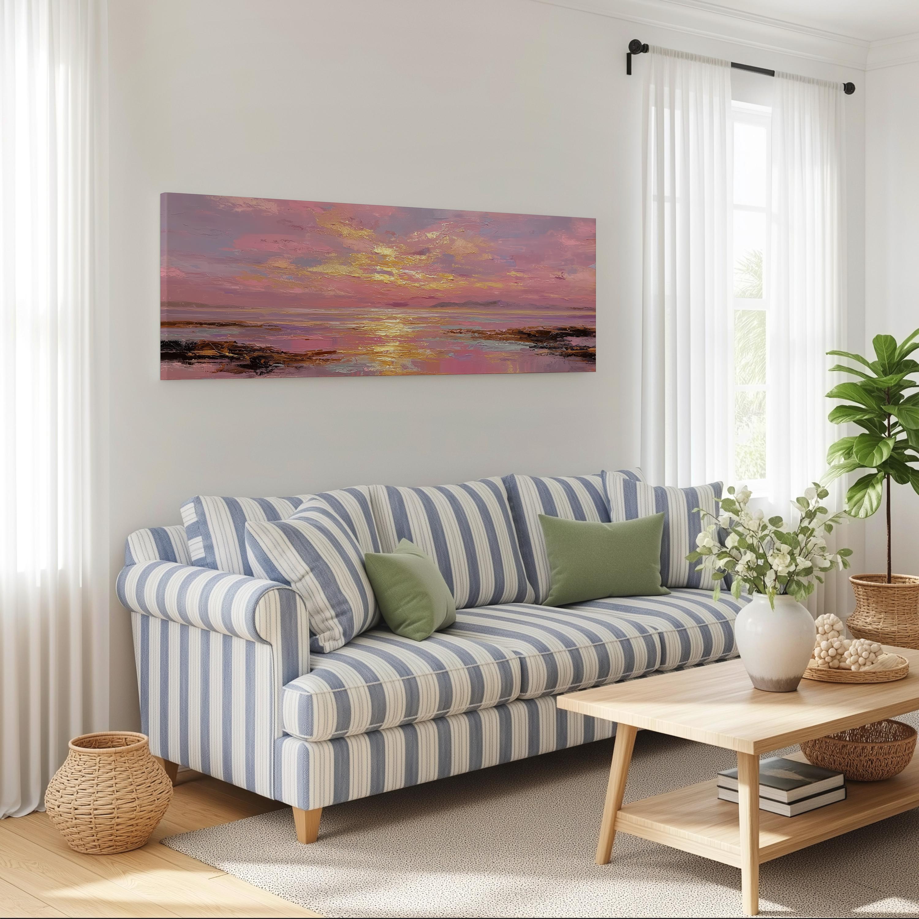 a cozy living room with a striped blue and white sofa, a wooden coffee table, and a large window with white curtains. Above the sofa, there is a large painting of a sunset over the ocean.