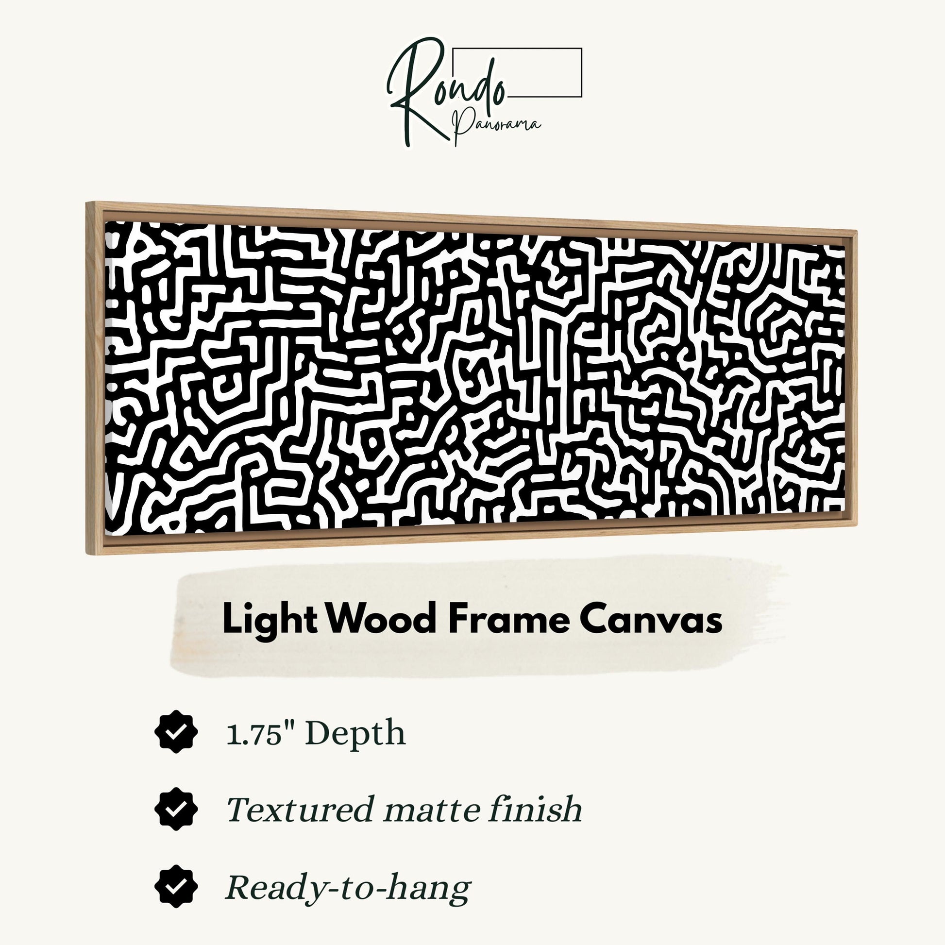 a light wood frame canvas with a black and white abstract pattern.
