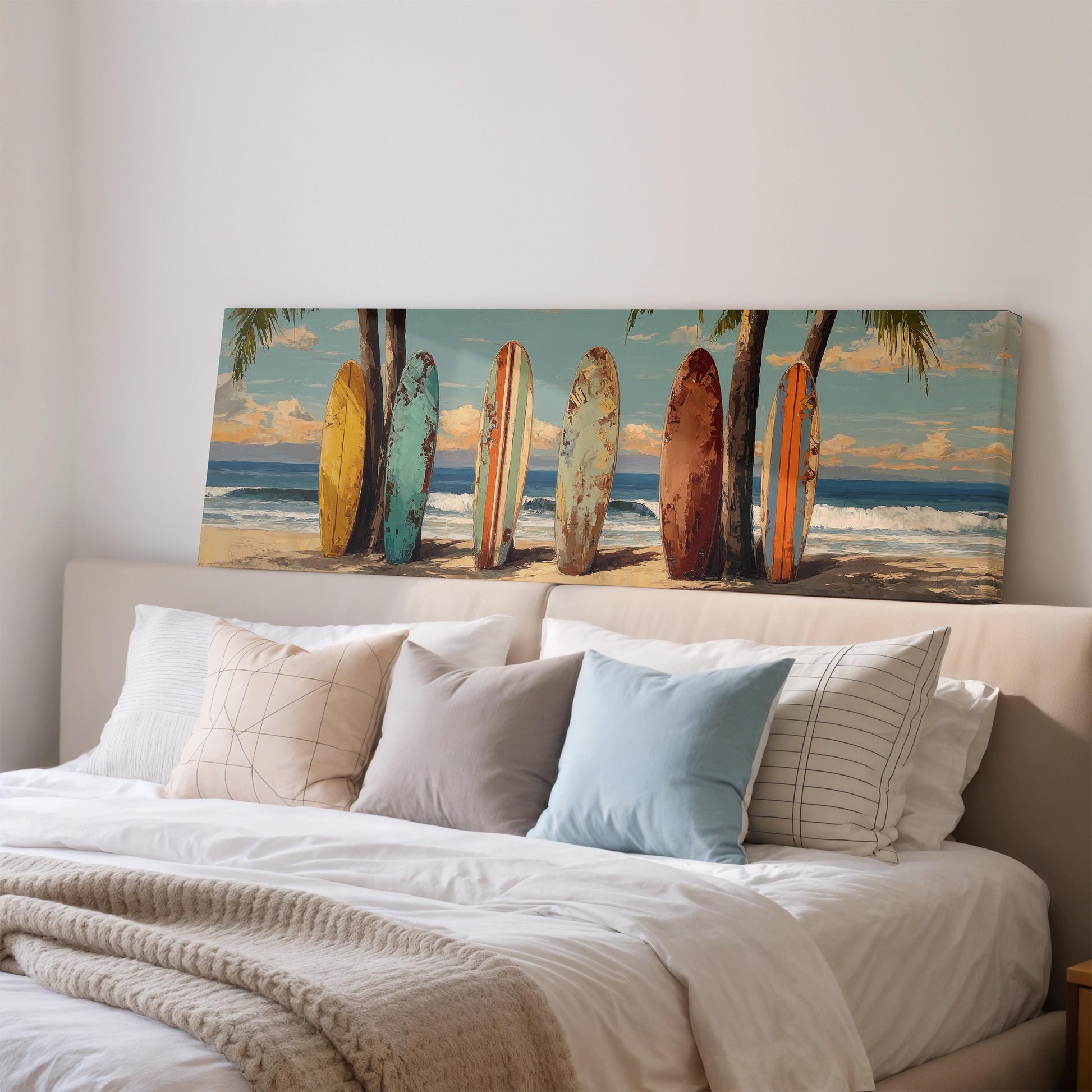 a bedroom with a large bed and a wall art depicting a beach scene with surfboards lined up on the sand.