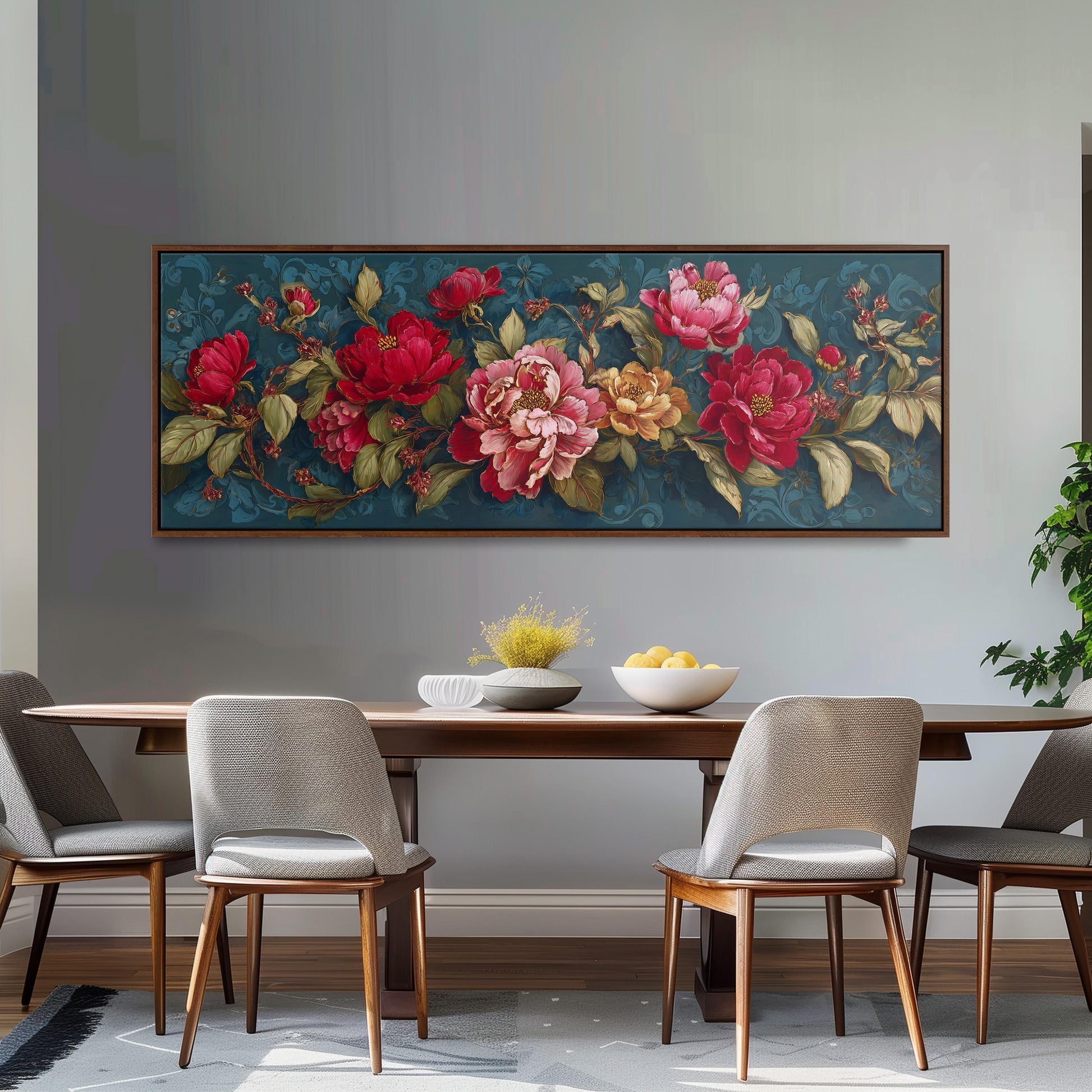 a dining room with a large floral painting hanging on the wall above a wooden table with four chairs. The table is set with a bowl of fruit and a vase of flowers, creating a cozy and inviting atmosphere.