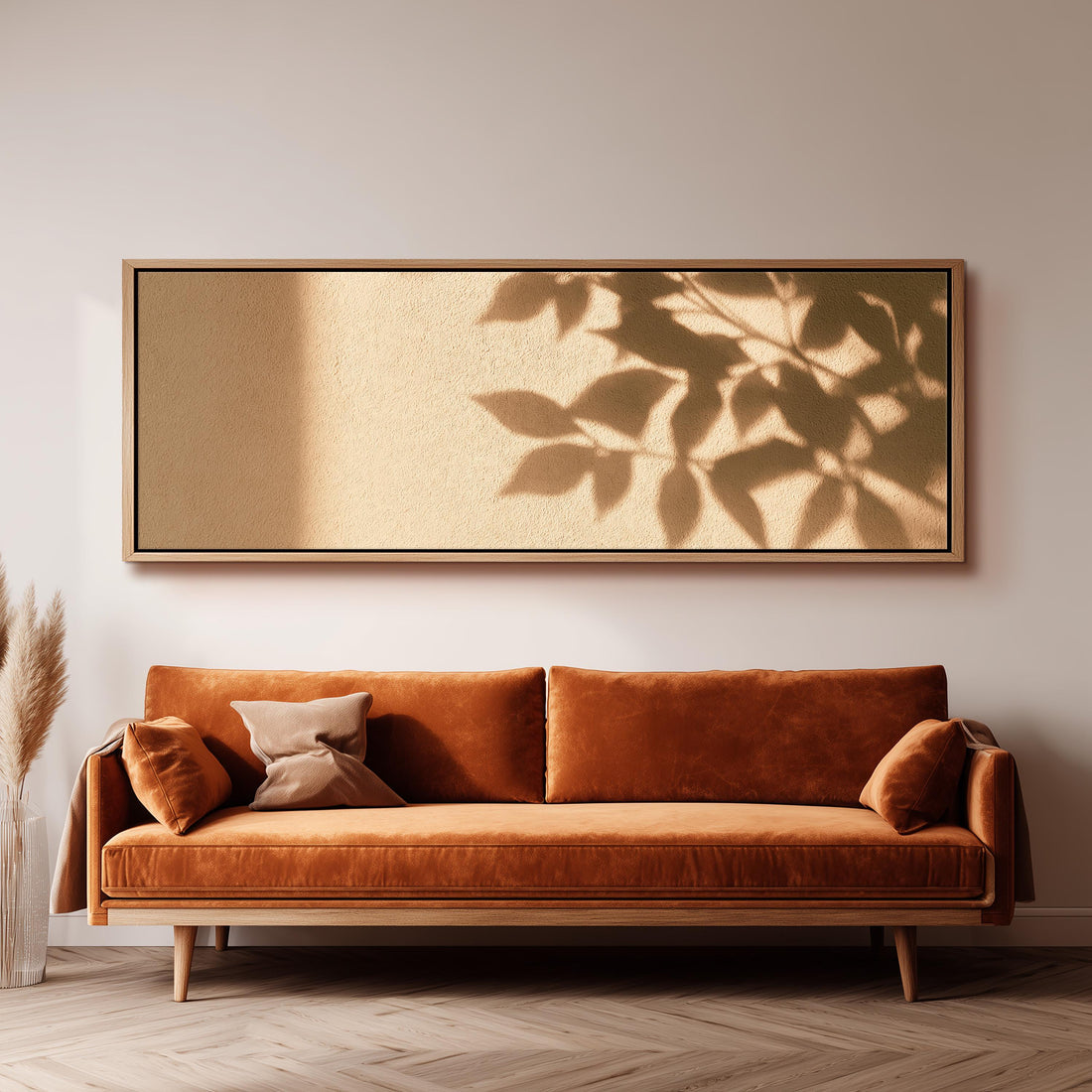 Leaf shadows on a golden plaster wall long horizontal canvas print above a sofa in a living room