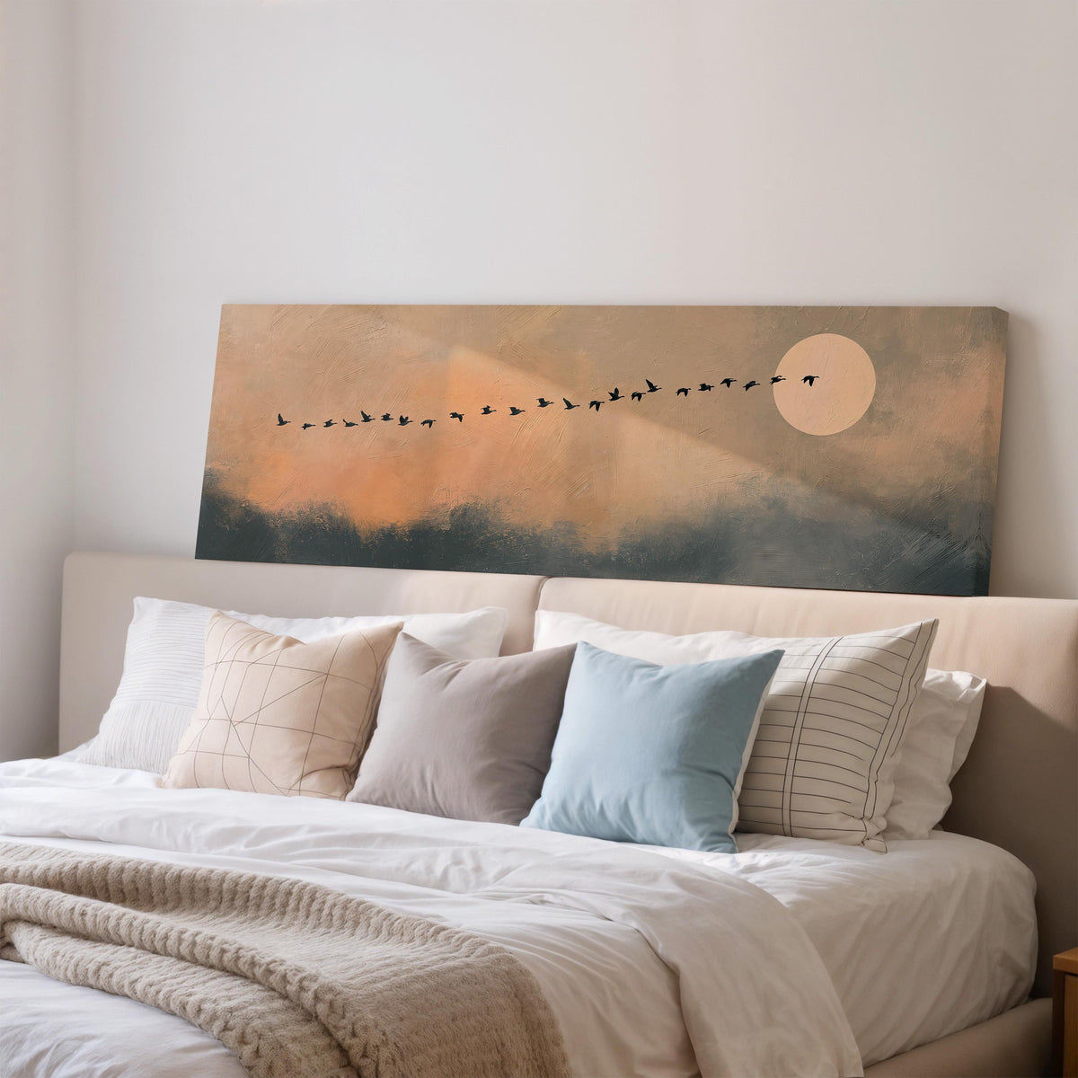 Migrating birds passing a moon at peach dusk wide panoramic canvas print above a bed in a bedroom