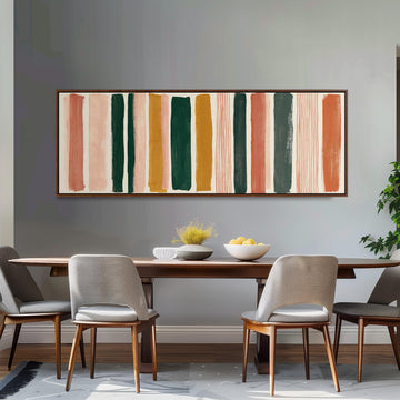 Mixed stripe blocks in terracotta, pink and green long horizontal canvas print above a sofa in a living room