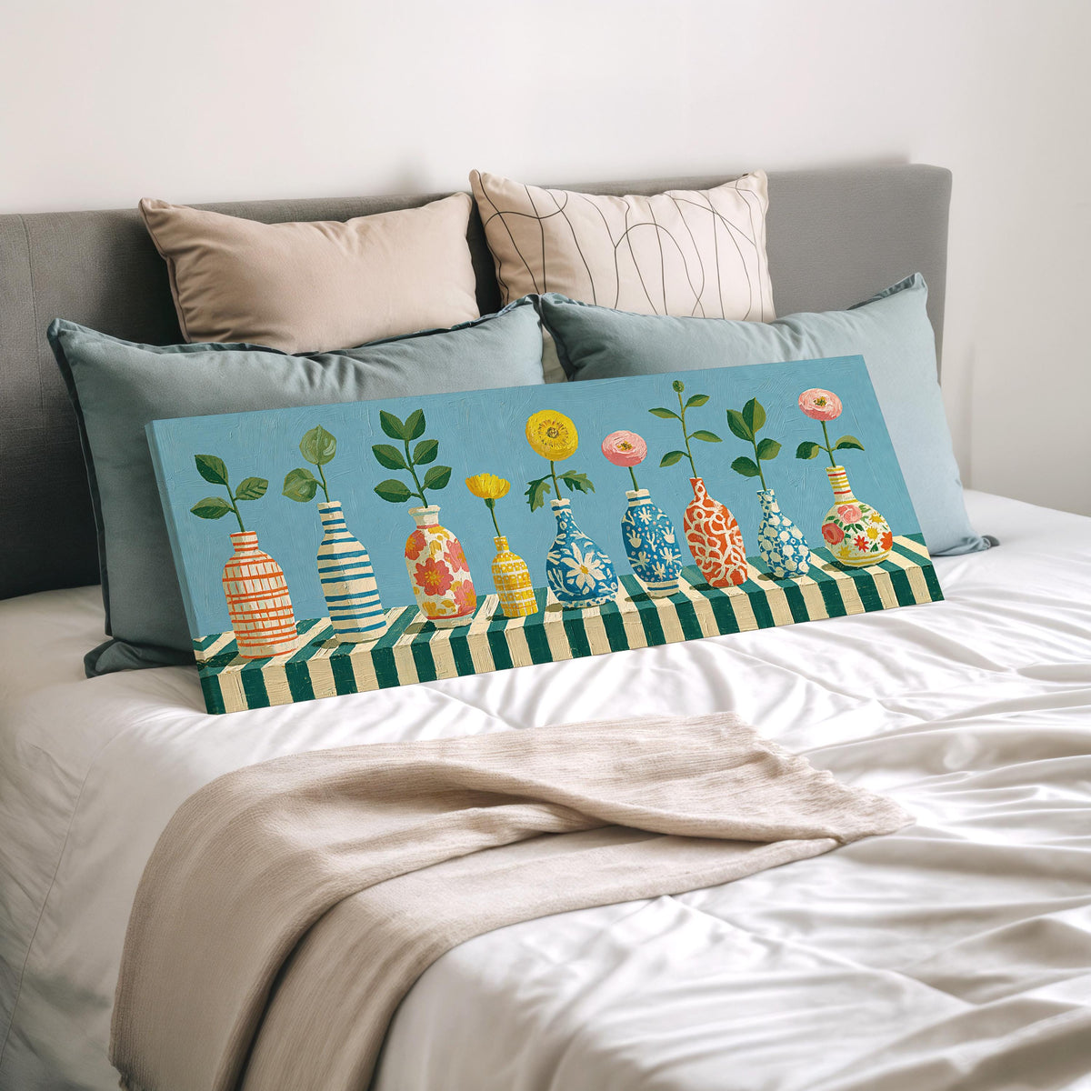 Row of striped vases with flowers wide panoramic canvas print laid on a bed to show its size