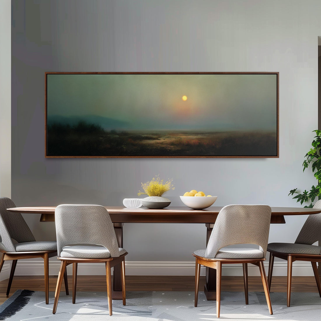 a dining room with a large painting of a landscape hanging on the wall above a wooden dining table with four chairs. The painting depicts a serene landscape with a sunset in the background.
