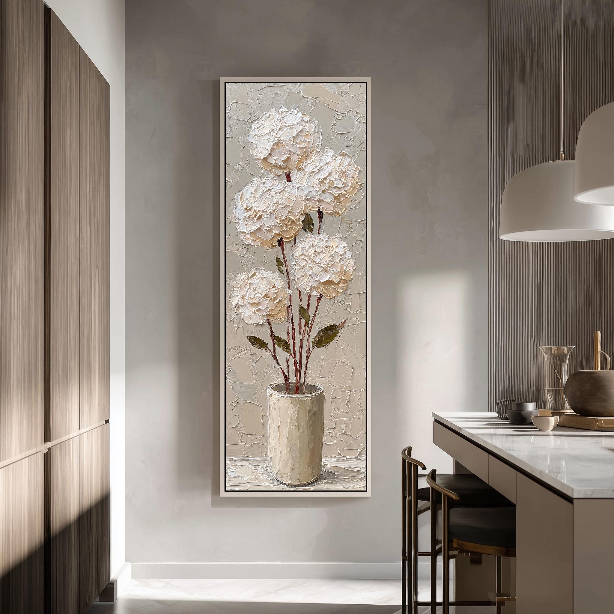 a large painting of white flowers in a vase hanging on a wall in a modern kitchen.