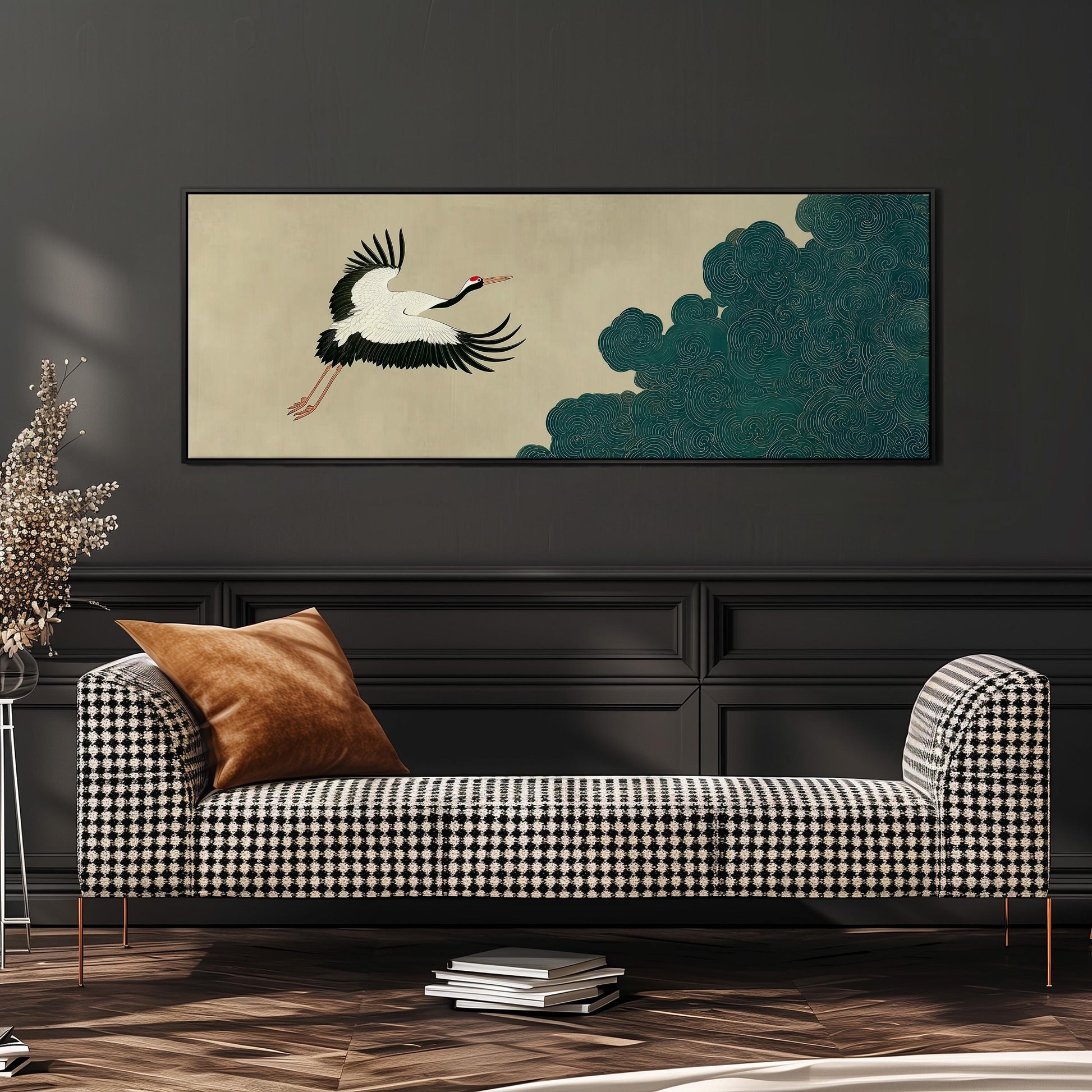 a black and white checkered sofa with a brown throw pillow, set against a dark wall with a framed artwork of a crane in flight above it.