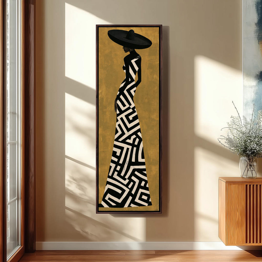 Woman in a geometric gown and wide hat on gold long vertical canvas print in a sunlit living space