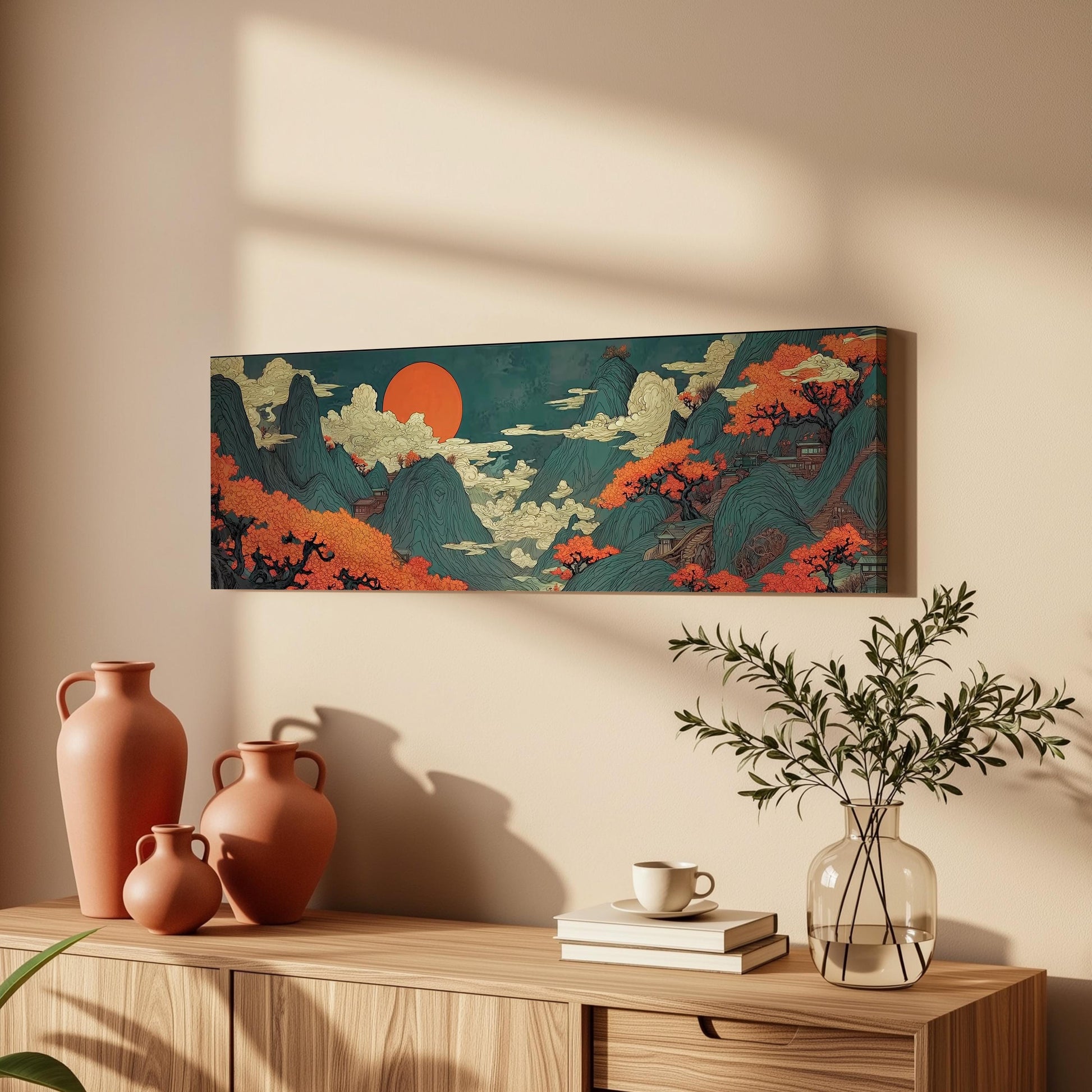 a wooden cabinet with a vase, a stack of books, and a plant, all set against a wall with a large, colorful painting hanging above it.