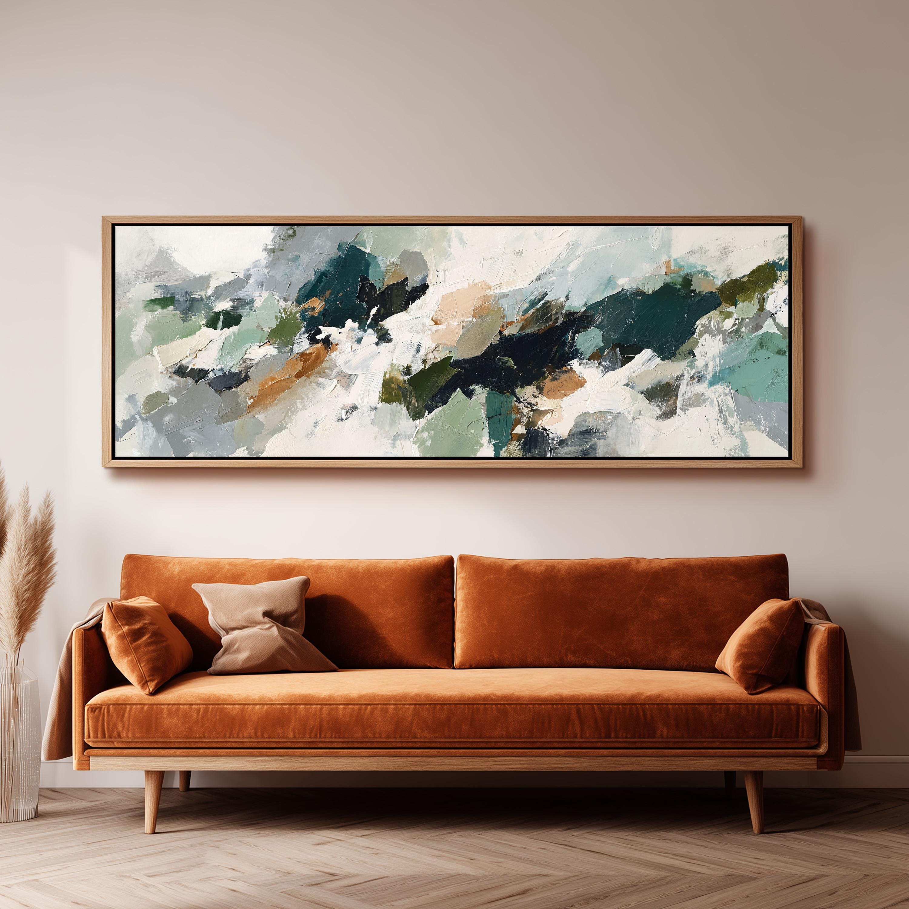 a large abstract painting hanging on a wall above a brown sofa with orange cushions.
