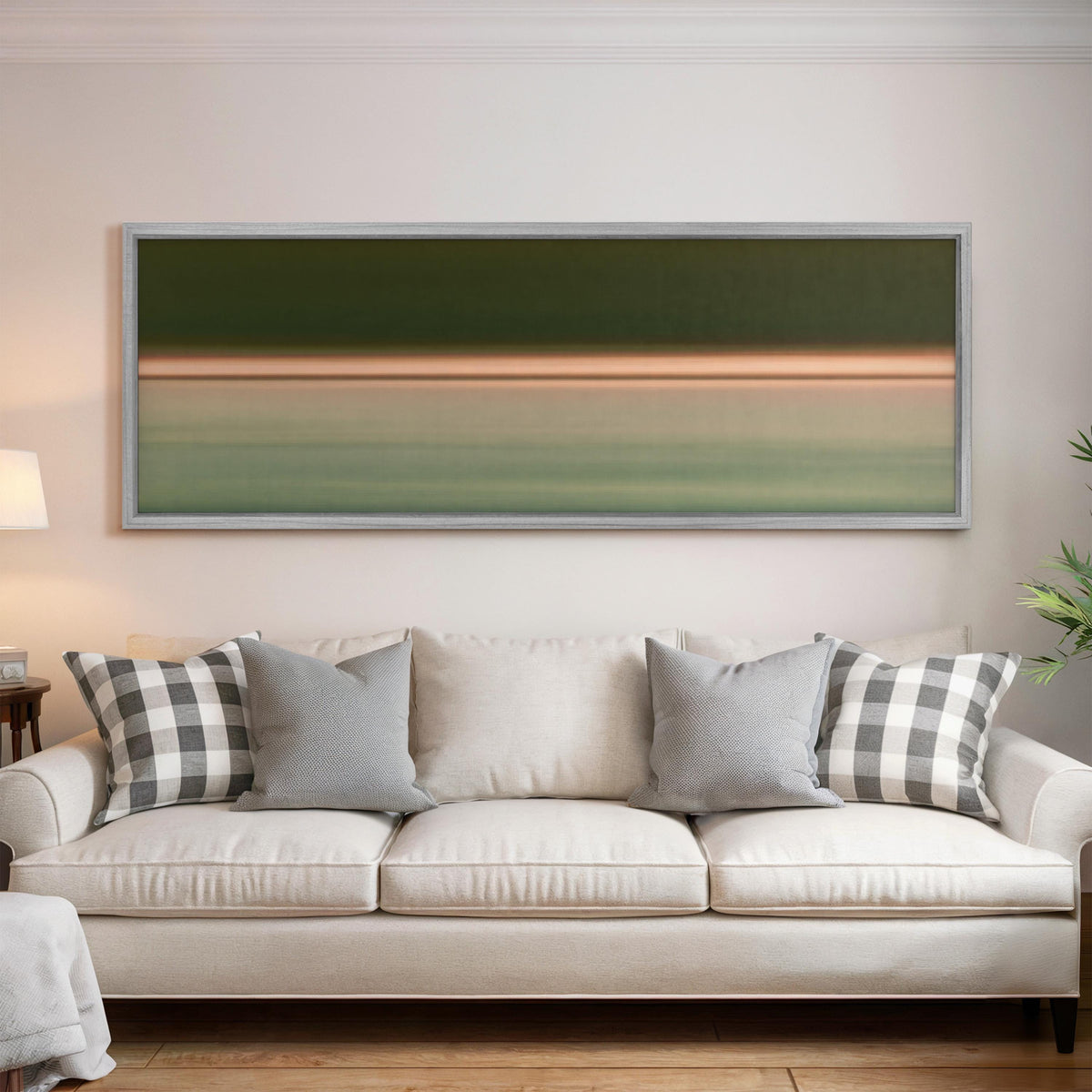 Minimalist dusk horizon gradient panoramic canvas print above a white sofa in a bright living room