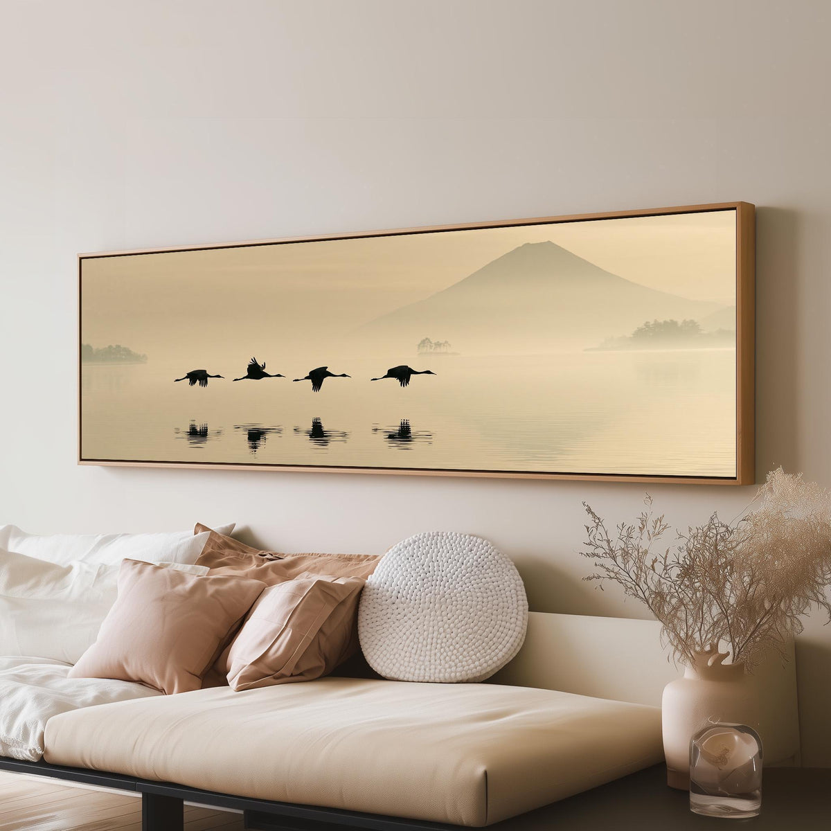 Birds flying low over a lake below Mount Fuji long horizontal canvas print above a sofa in a living room