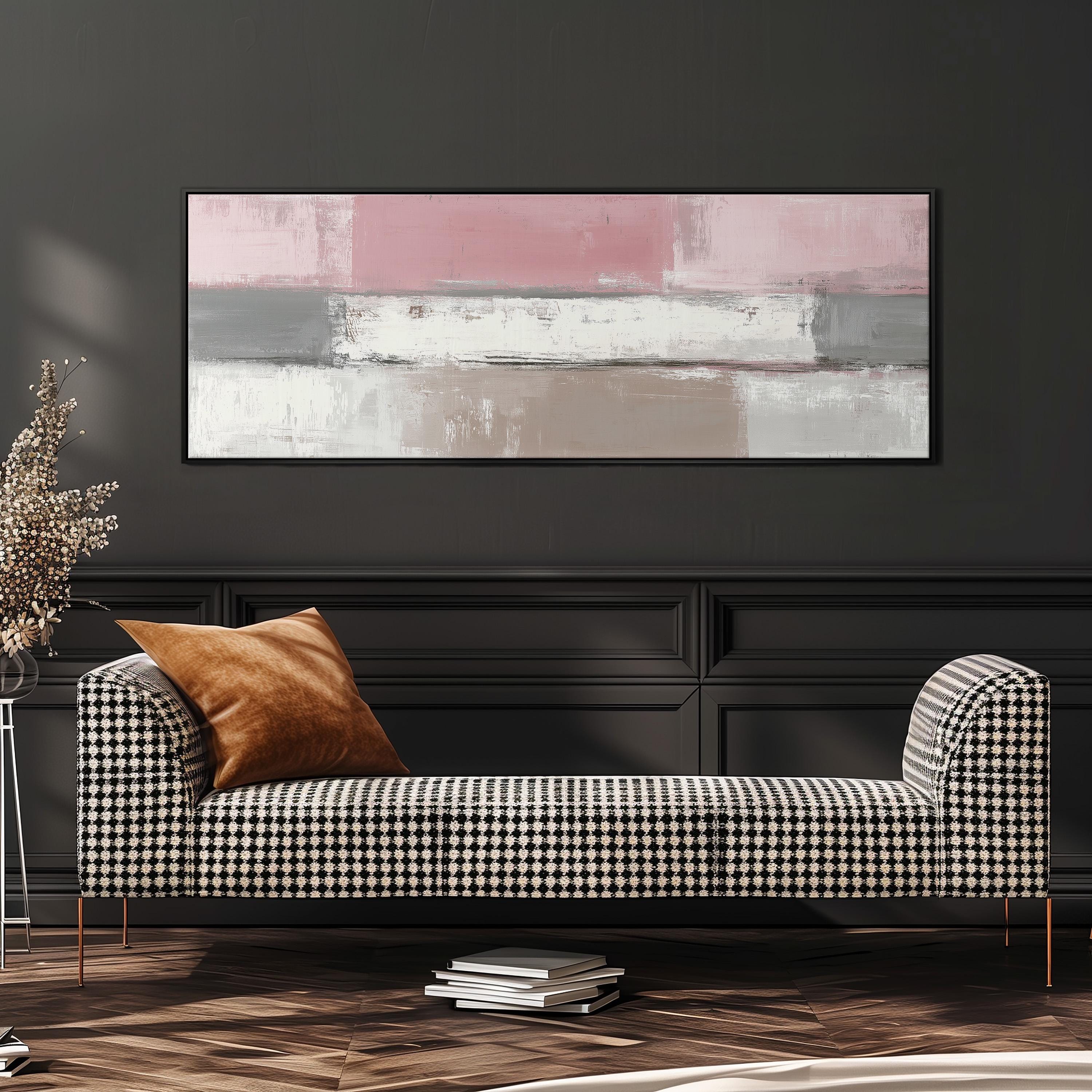 a modern living room with a black and white checkered sofa, a large abstract painting on the wall, and a stack of books on the floor.