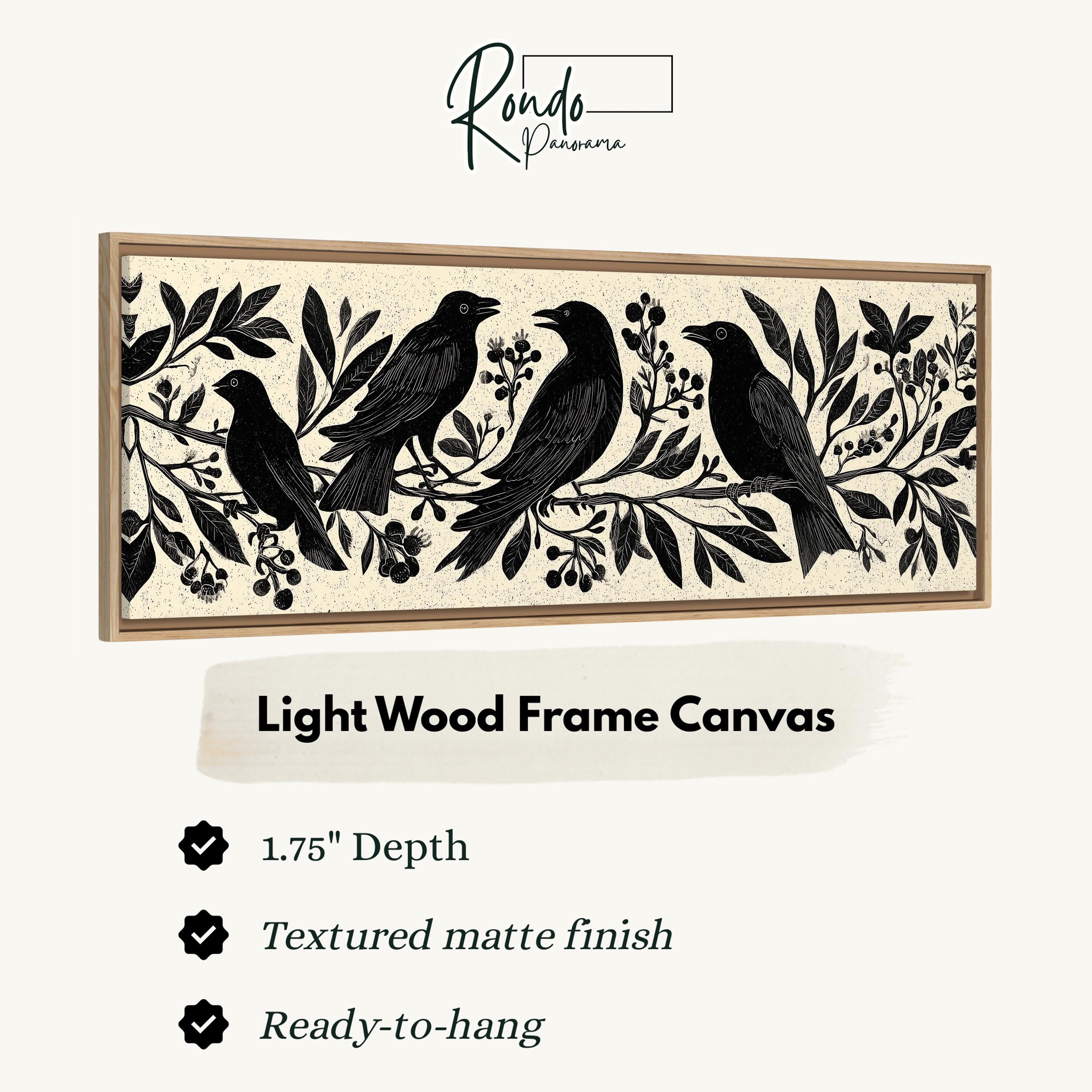 a light wood frame canvas with a black and white illustration of four birds perched on branches with leaves and berries.