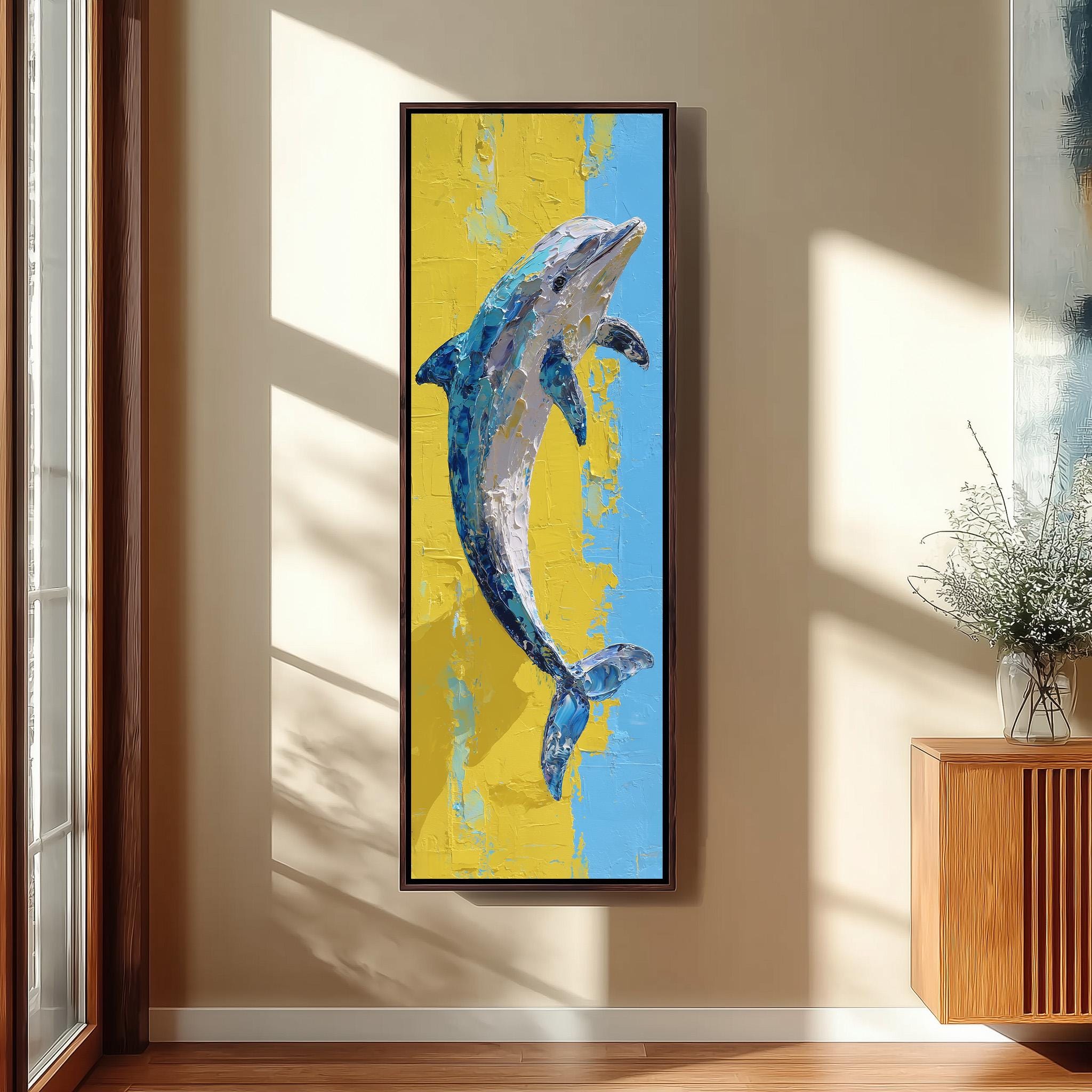 a large framed painting of a dolphin hanging on a wall in a room with a wooden cabinet and a vase of flowers.