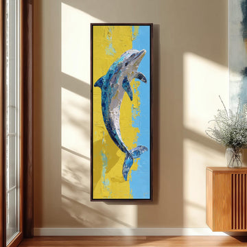 a large framed painting of a dolphin hanging on a wall in a room with a wooden cabinet and a vase of flowers.