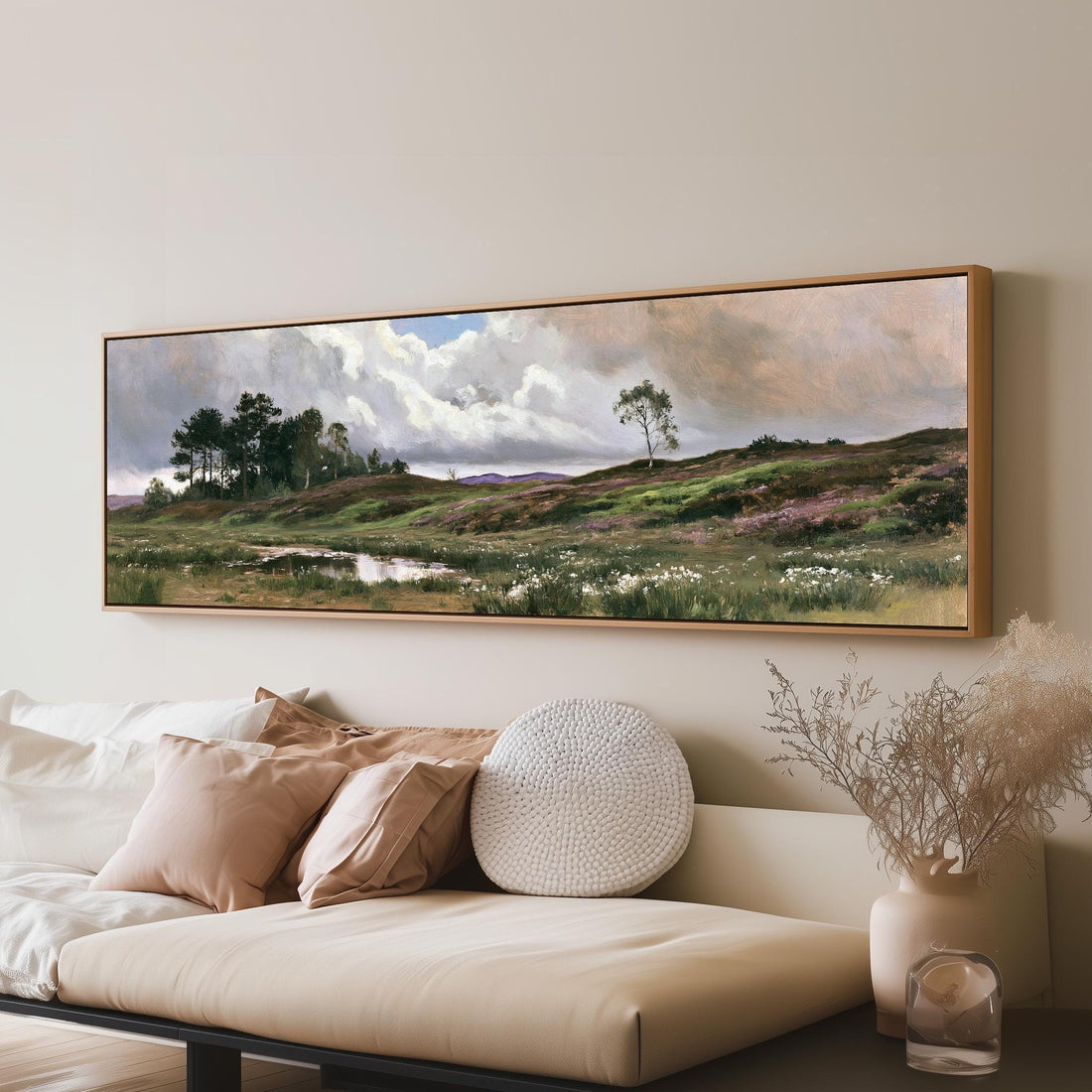 Windswept countryside heath under big clouds long horizontal canvas print above a sofa in a living room