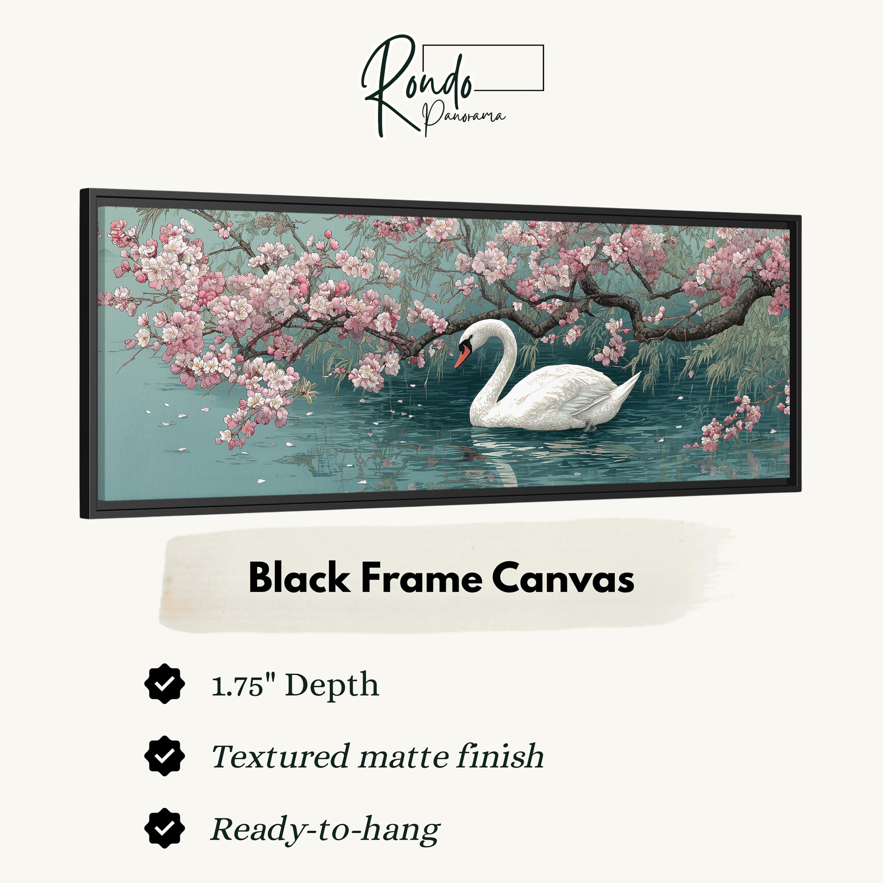 A framed artwork depicting a swan swimming in a pond with pink flowers and branches.