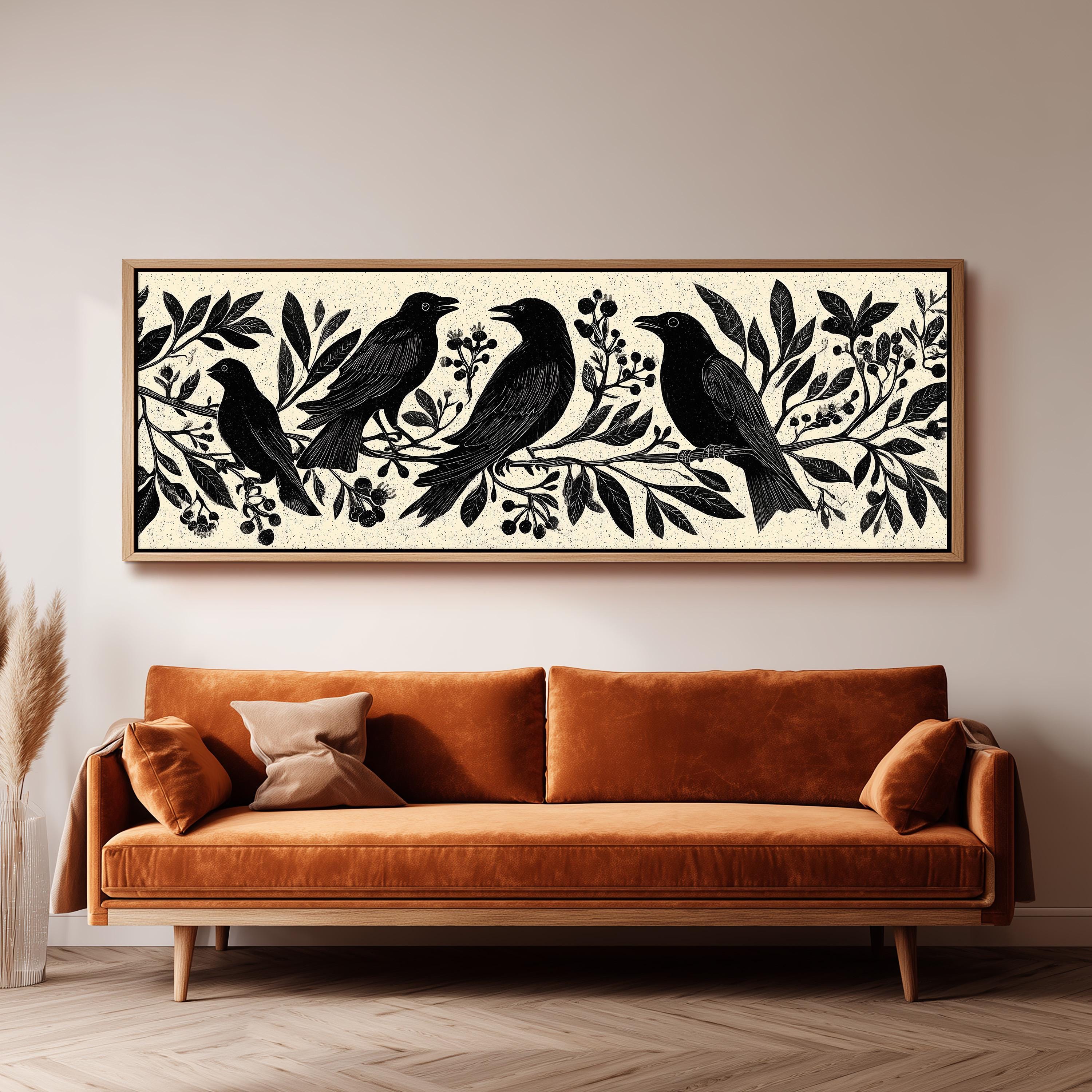 a large black and white print of a bird sitting on a branch, hanging on a wall above a brown sofa.