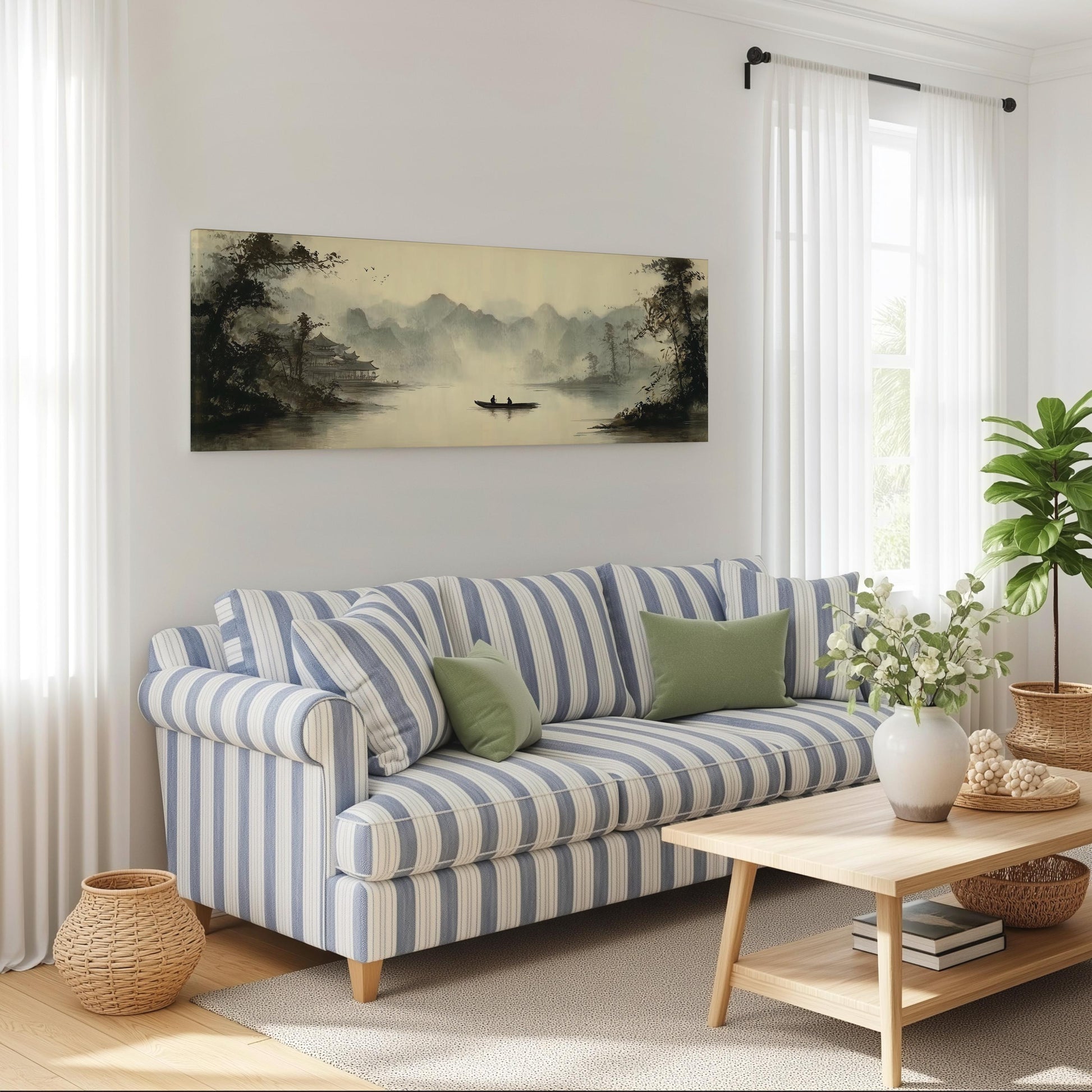 a cozy living room with a striped blue and white sofa, a wooden coffee table, and a large landscape painting hanging on the wall.