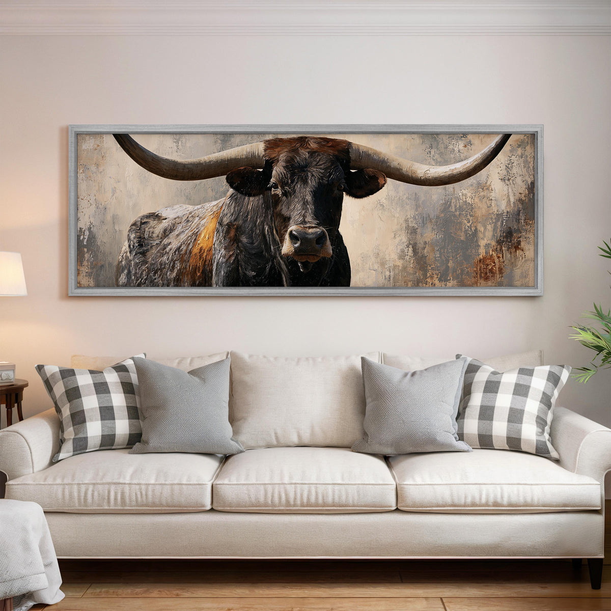 Longhorn bull portrait panoramic canvas print above a white sofa in a bright living room