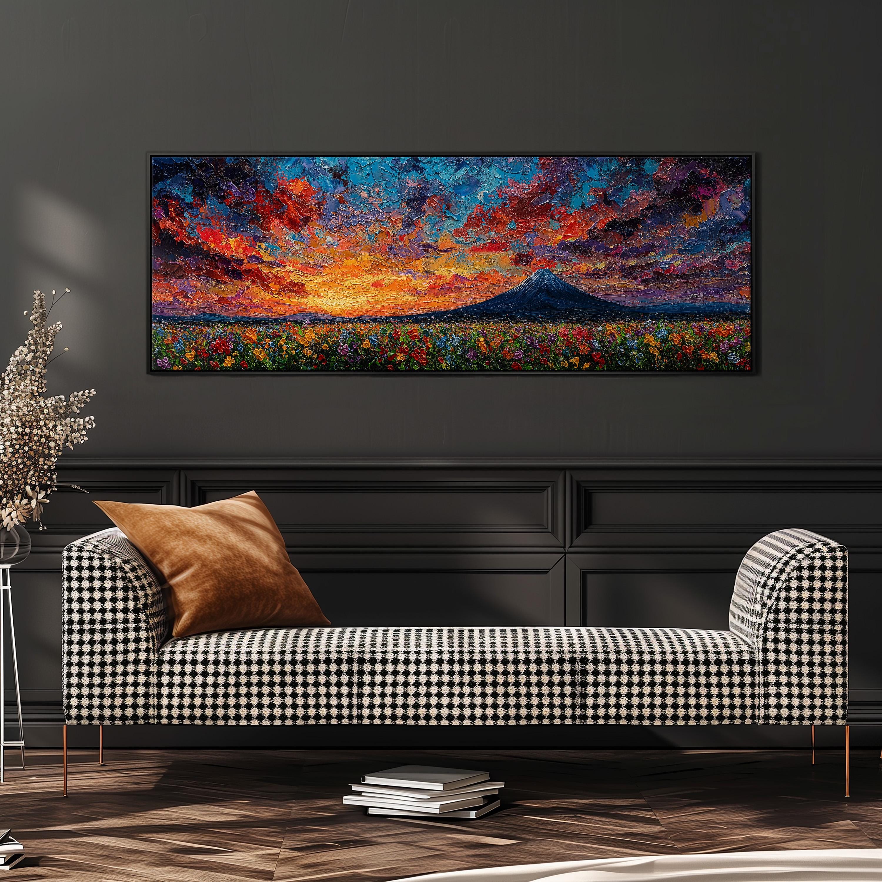 a large, colorful painting of a mountain landscape hanging on a wall above a black and white checkered sofa.