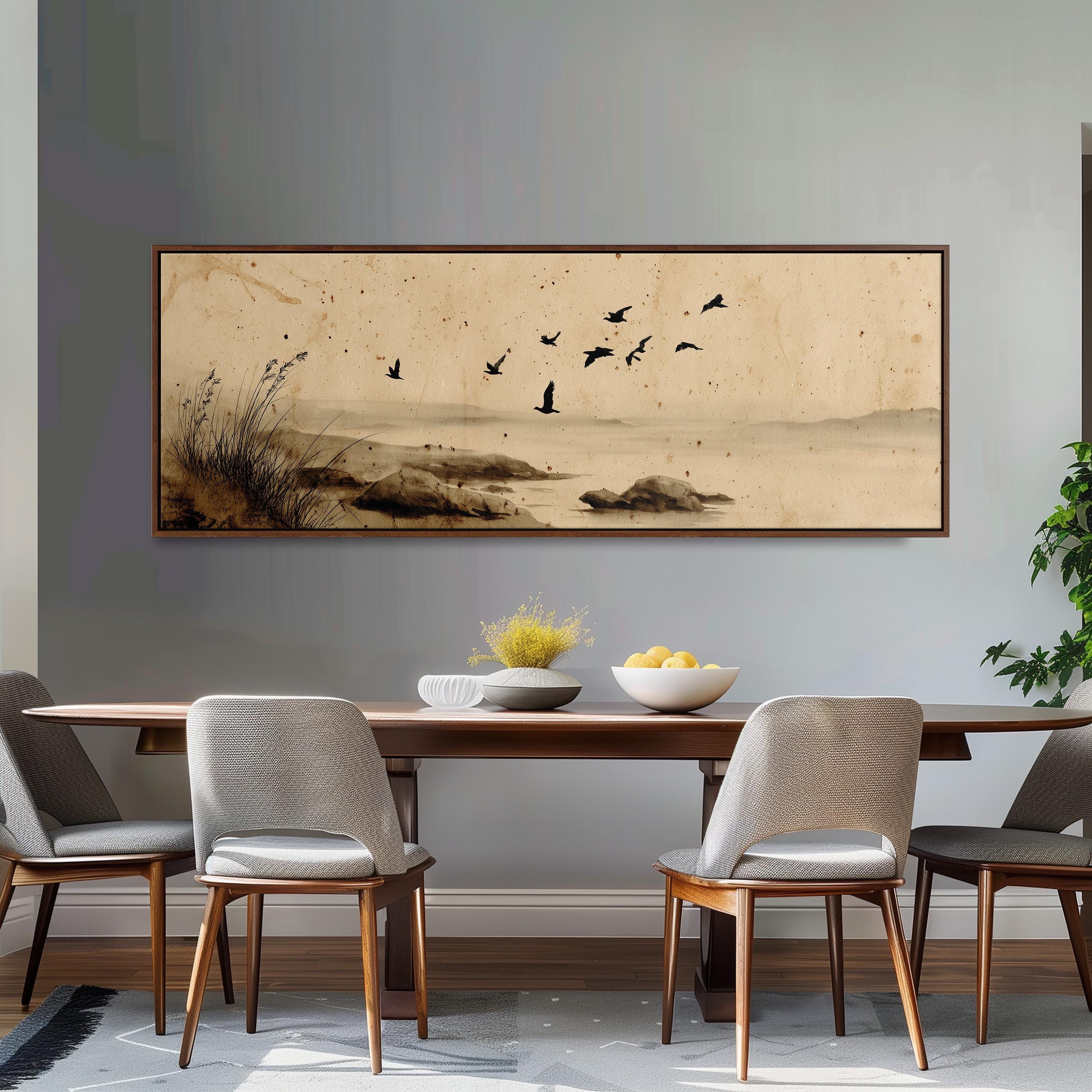 a dining room with a large painting of birds in flight above a wooden table, which has a bowl of fruit and a vase on it. The table is surrounded by four chairs, and there is a plant in the corner of the room.