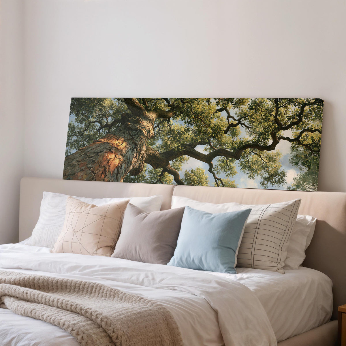 Ancient oak trunk and branches seen from below wide panoramic canvas print above a bed in a bedroom