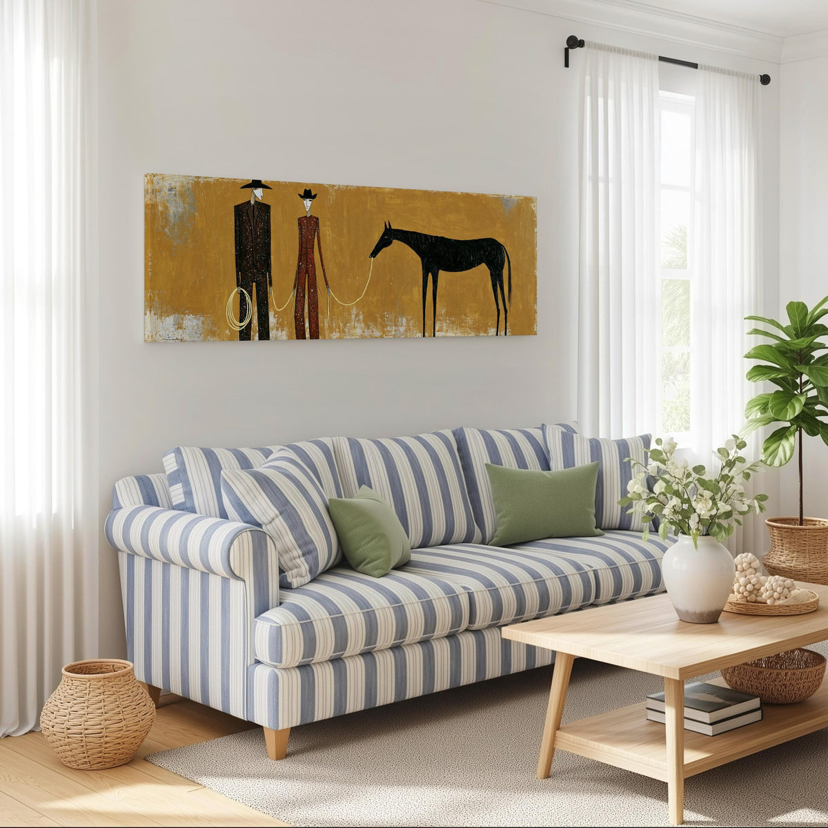 Two cowboys with a dark horse on gold long horizontal canvas print above a striped sofa in a coastal living room