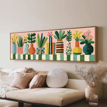 Row of boho potted plants long horizontal canvas print above a sofa in a living room